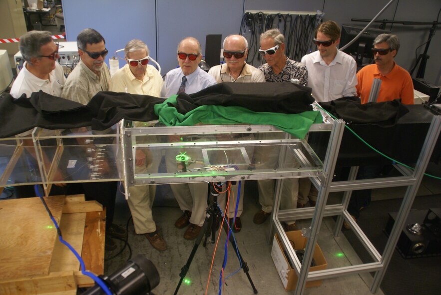 From left, AEDC’s Fred Heltsley, with guests Peter Sherrouse, Henry Bevis, Don Brayton, Donnie Inglish, Virgil Cline, Dr. Todd Lowe and Ronnie Rogers, an LDV data reduction software developer, get to look at the new SM3 LDV operating in the laser lab wind tunnel. The five AEDC LDV pioneers recently met with Dr. Lowe and Heltsley to socialize, discuss their work and learn what the future will hold in their area of expertise.