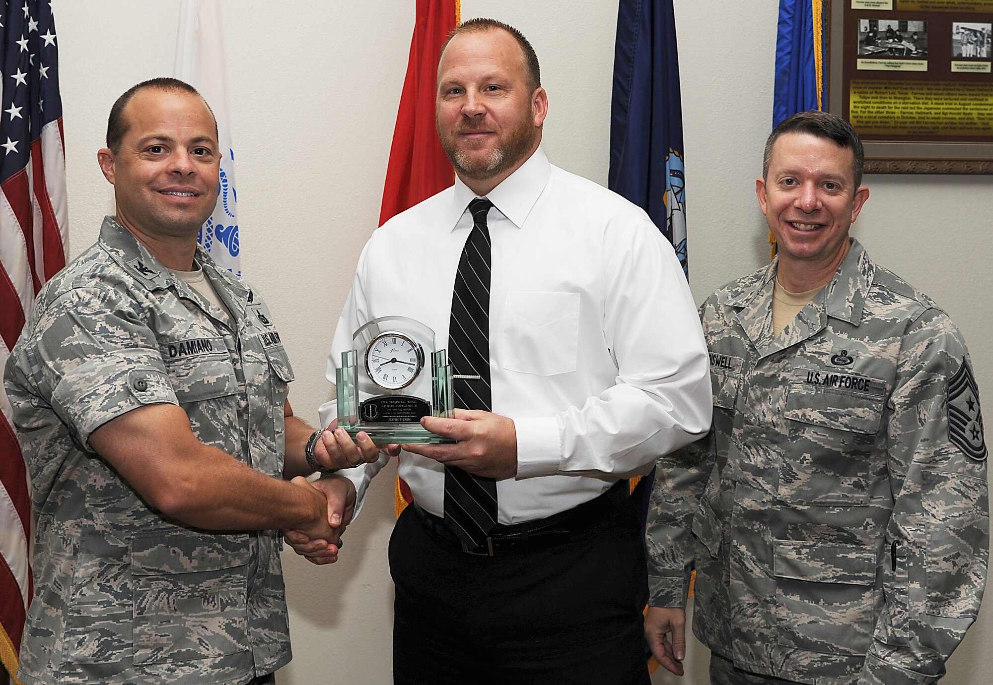 GOODFELLOW AIR FORCE BASE, Texas -- Col. Mark Damiano, 17th Training Wing Commander, and Chief Master Sgt. Brendan Criswell, 17th TRW Command Chief, present Jeffrey Crim, 17th Mission Support Group, with the 17th TRW Civilian of the Quarter Category II Award for the third quarter.  (U.S. Air Force photo/Airman 1st Class Michael Smith)