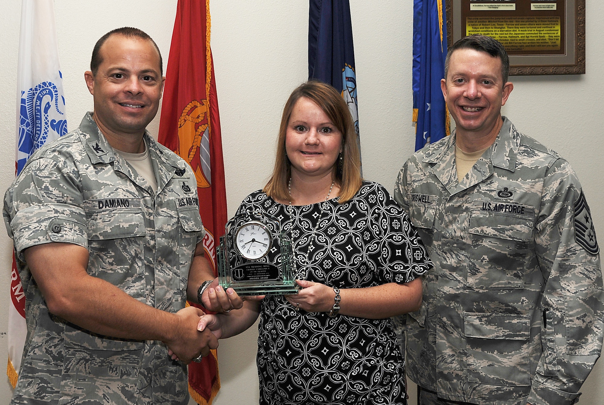 GOODFELLOW AIR FORCE BASE, Texas -- Col. Mark Damiano, 17th Training Wing Commander, and Chief Master Sgt. Brendan Criswell, 17th TRW Command Chief, present Amanda Adams, 17th Medical Group, with the 17th TRW Civilian of the Quarter Category I Award for the third quarter.  (U.S. Air Force photo/Airman 1st Class Michael Smith)