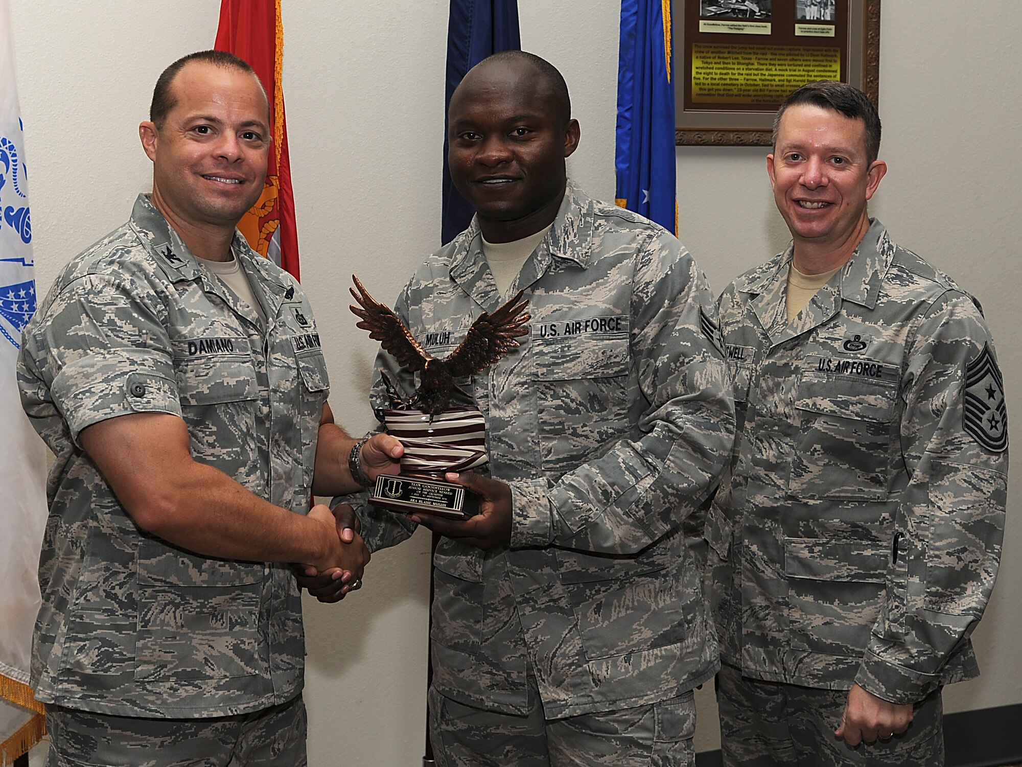 GOODFELLOW AIR FORCE BASE, Texas -- Col. Mark Damiano, 17th Training Wing Commander, and Chief Master Sgt. Brendan Criswell, 17th TRW Command Chief, present Senior Airman Blaise Muluh, 17th Medical Group, with the Team Goodfellow Junior Enlisted of the Quarter Award for the third quarter.  (U.S. Air Force photo/Airman 1st Class Michael Smith)