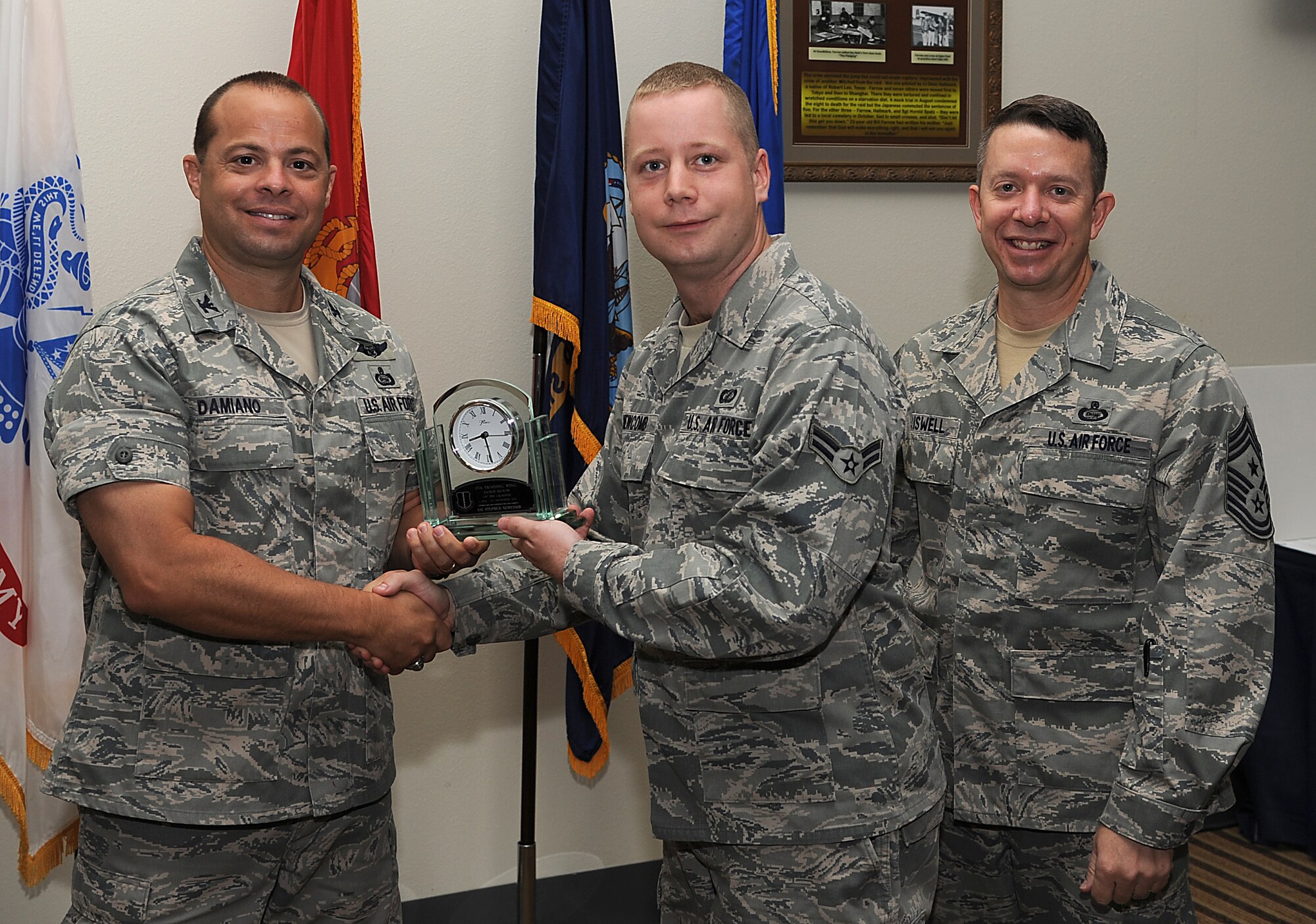 GOODFELLOW AIR FORCE BASE, Texas -- Col. Mark Damiano, 17th Training Wing Commander, and Chief Master Sgt. Brendan Criswell, 17th TRW Command Chief, present Airman 1st Class Stephen Newcomb, 17th Mission Support Group, with the 17th TRW Dorm Room of the Quarter Award for the third quarter.  (U.S. Air Force photo/Airman 1st Class Michael Smith)