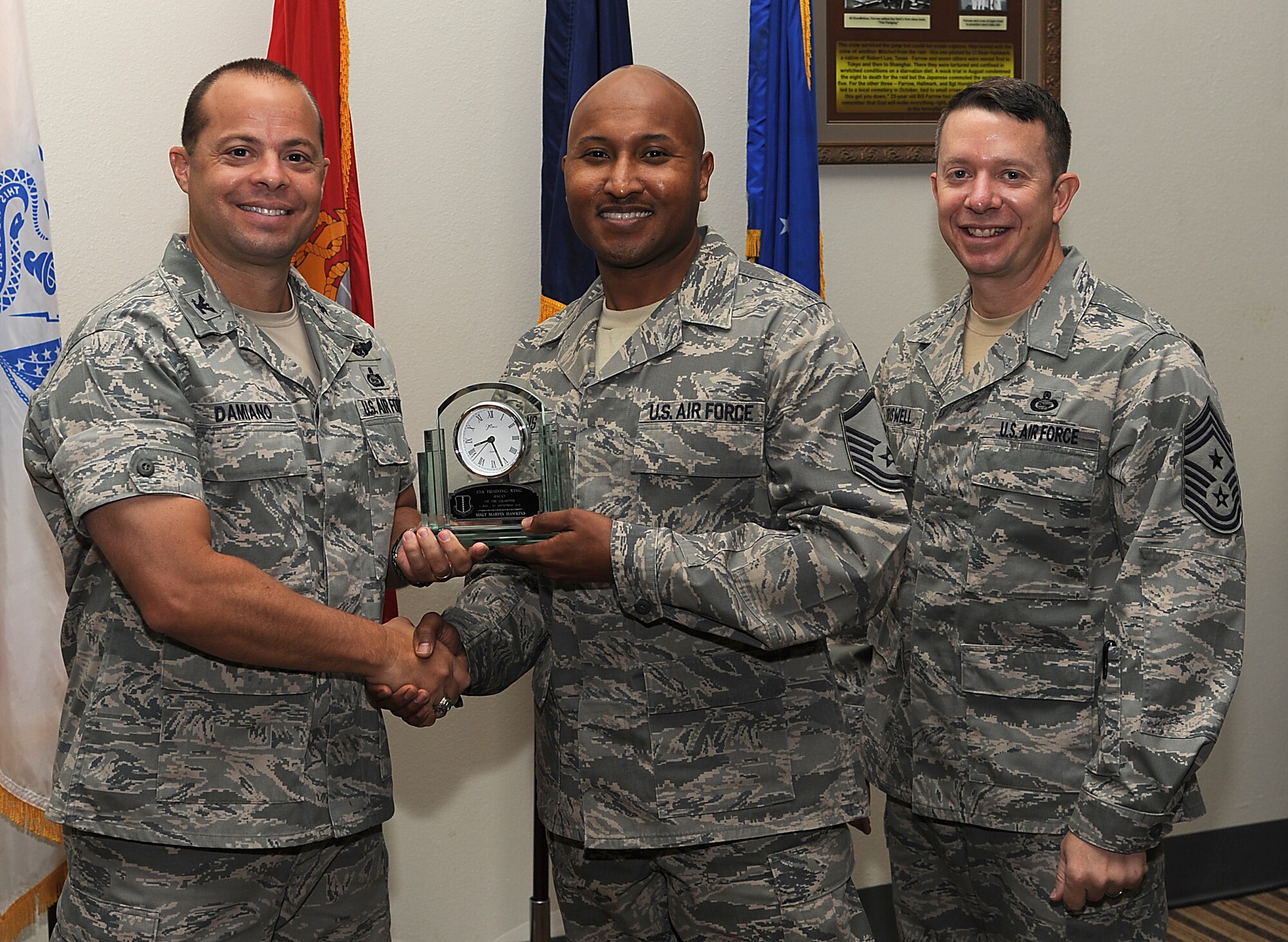 GOODFELLOW AIR FORCE BASE, Texas -- Col. Mark Damiano, 17th Training Wing Commander, and Chief Master Sgt. Brendan Criswell, 17th TRW Command Chief, present Master Sgt. Marvin Hawkins, 17th Medical Group, with the 17th TRW Senior NCO of the Quarter Award for the third quarter.  (U.S. Air Force photo/Airman 1st Class Michael Smith)