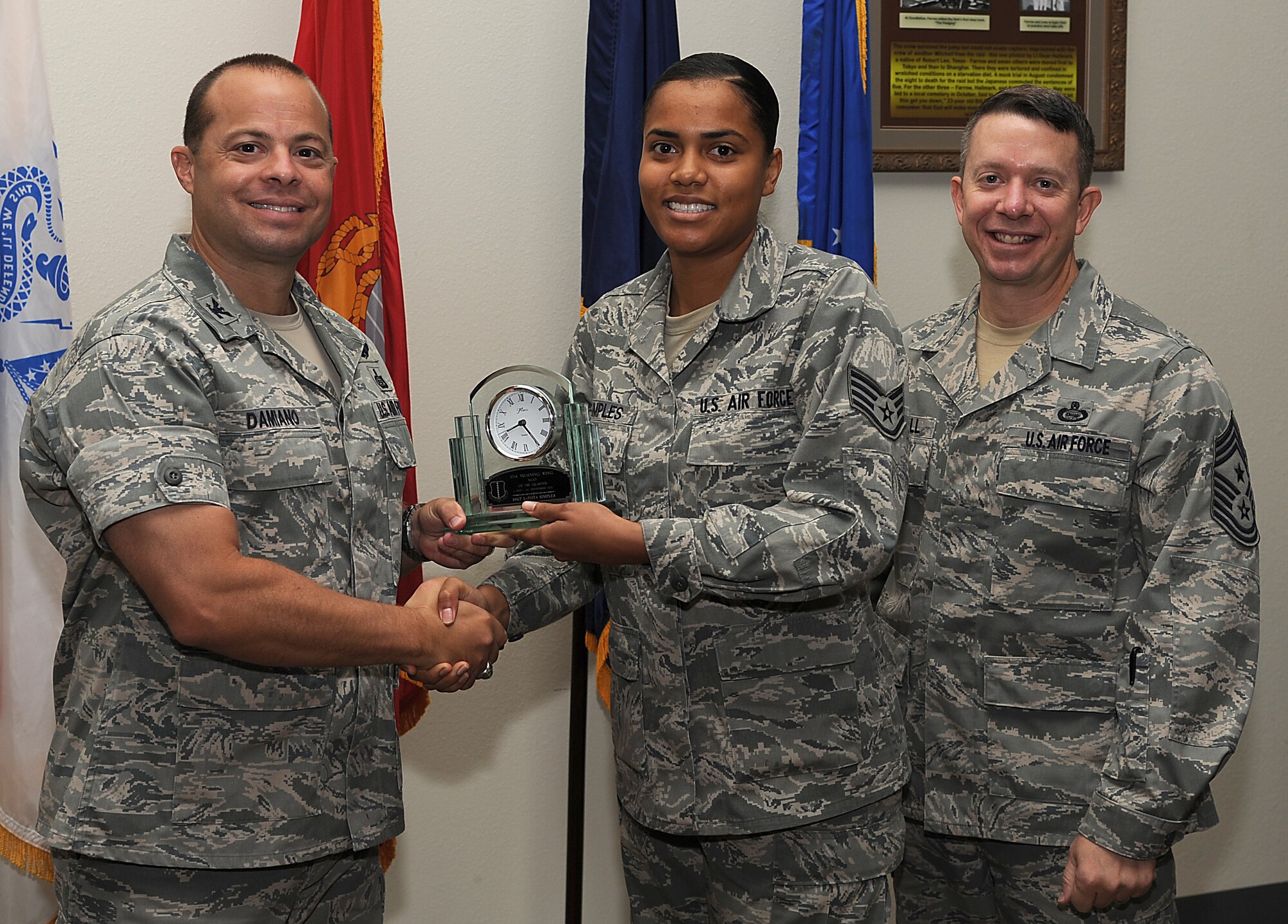 GOODFELLOW AIR FORCE BASE, Texas -- Col. Mark Damiano, 17th Training Wing Commander, and Chief Master Sgt. Brendan Criswell, 17th TRW Command Chief, present Staff Sgt. LaToya Simples, 17th Medical Group, with the 17th TRW NCO of the Quarter Award for the third quarter.  (U.S. Air Force photo/Airman 1st Class Michael Smith)