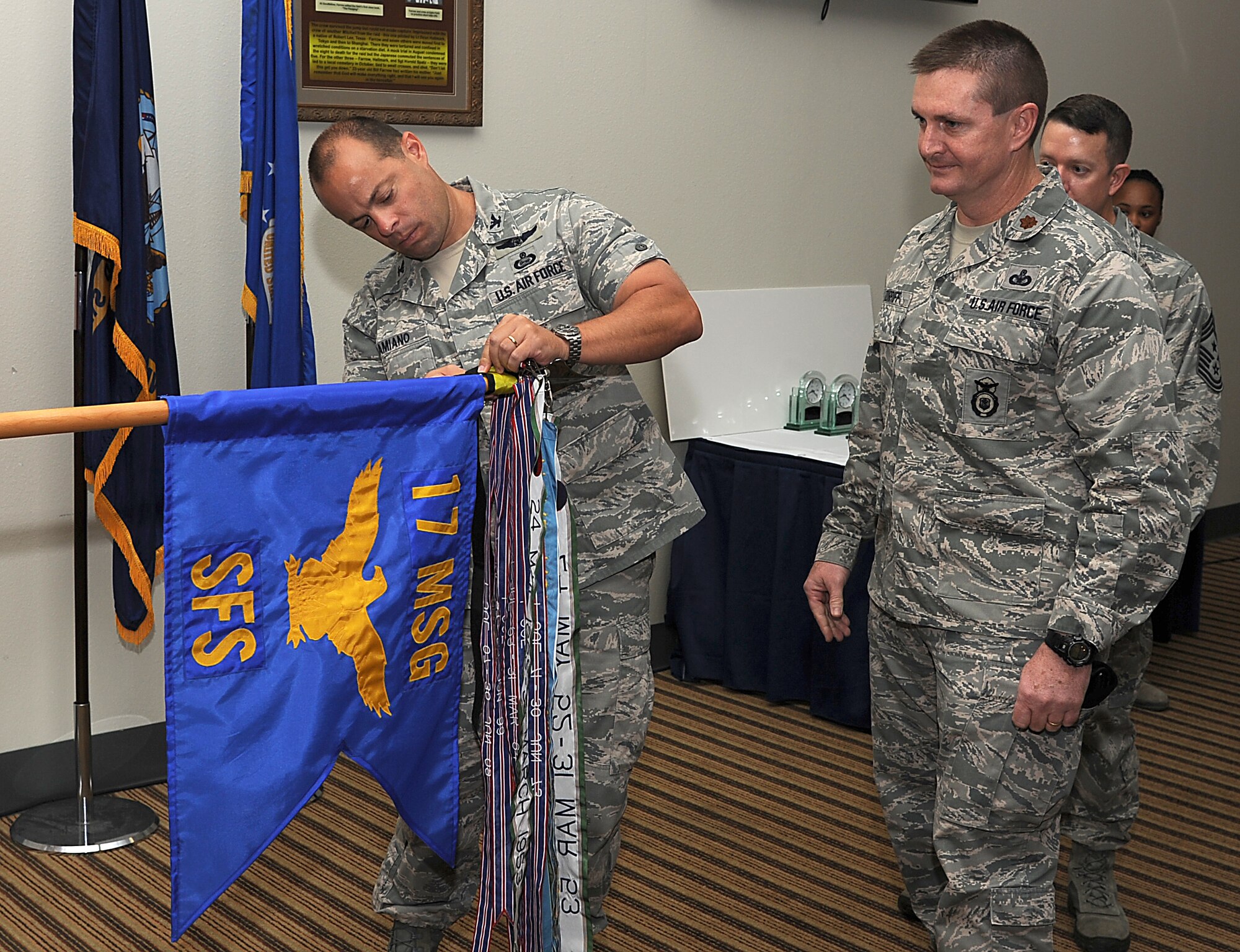 GOODFELLOW AIR FORCE BASE, Texas -- Col. Mark Damiano, 17th Training Wing Commander, presents Maj. Dennis Turriff, 17th Security Forces Squadron, with the 17th TRW Unit of the Quarter Award for the third quarter.  (U.S. Air Force photo/Airman 1st Class Michael Smith)