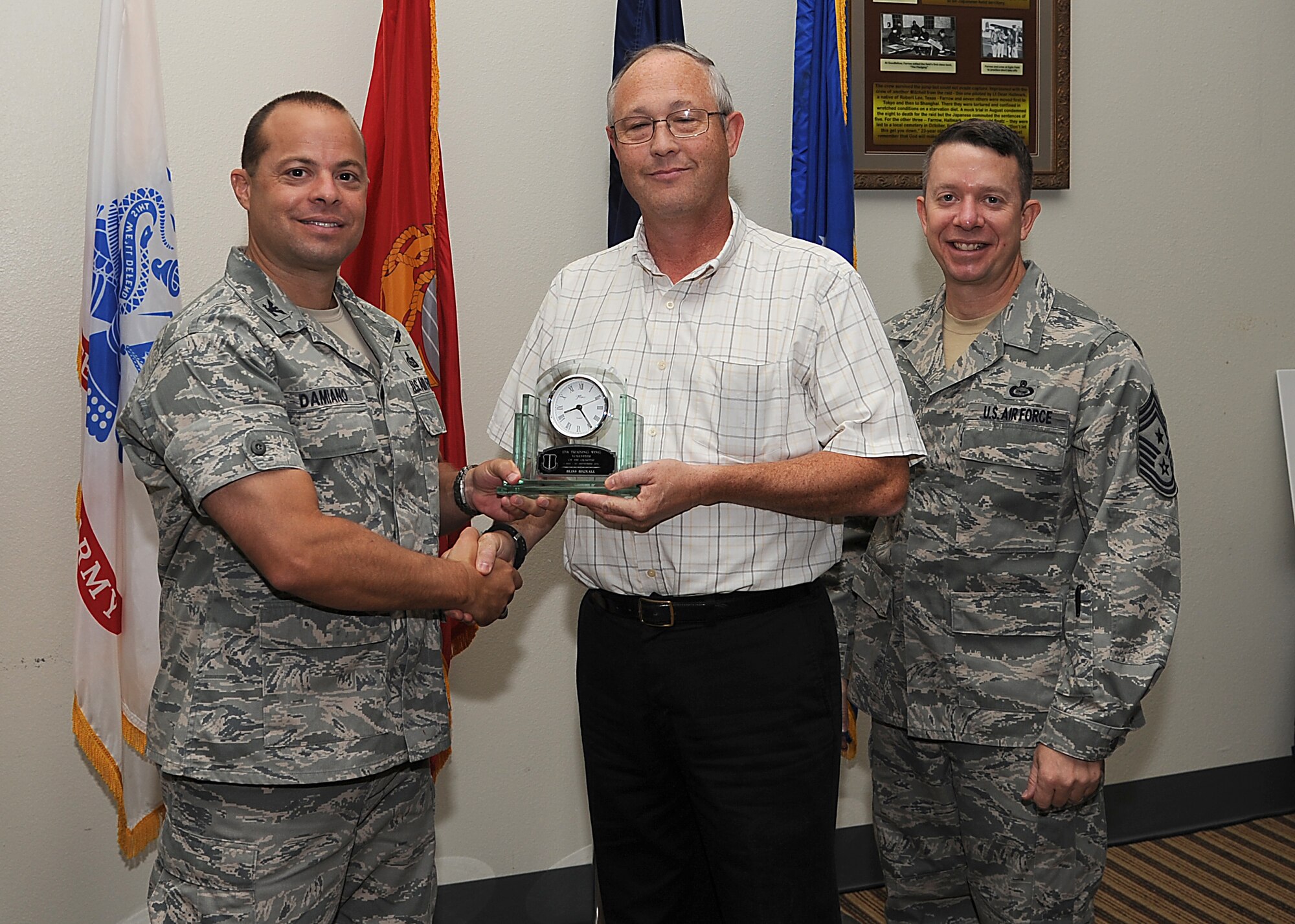 GOODFELLOW AIR FORCE BASE, Texas -- Col. Mark Damiano, 17th Training Wing Commander, and Chief Master Sgt. Brendan Criswell, 17th TRW Command Chief, present Bliss Bignall, 17th Training Group, with the 17th TRW Volunteer of the Quarter Award for the third quarter. (U.S. Air Force photo/Airman 1st Class Michael Smith)