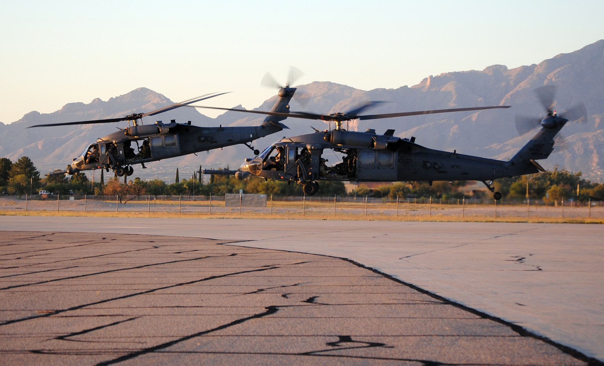 Two HH-60 Pave Hawk helicopters from the 943rd Rescue Group launch from Davis Monthan Air Force Base, Ariz. during a training alert mission as part of the Angel Thunder 2011 combat-search-and-rescue exercise. The multi-agency and multinational exercise had more than 1,400 participants involved in CSAR operations. (U.S. Air Force Photo/ Master Sgt. Gregory Gaunt) 
