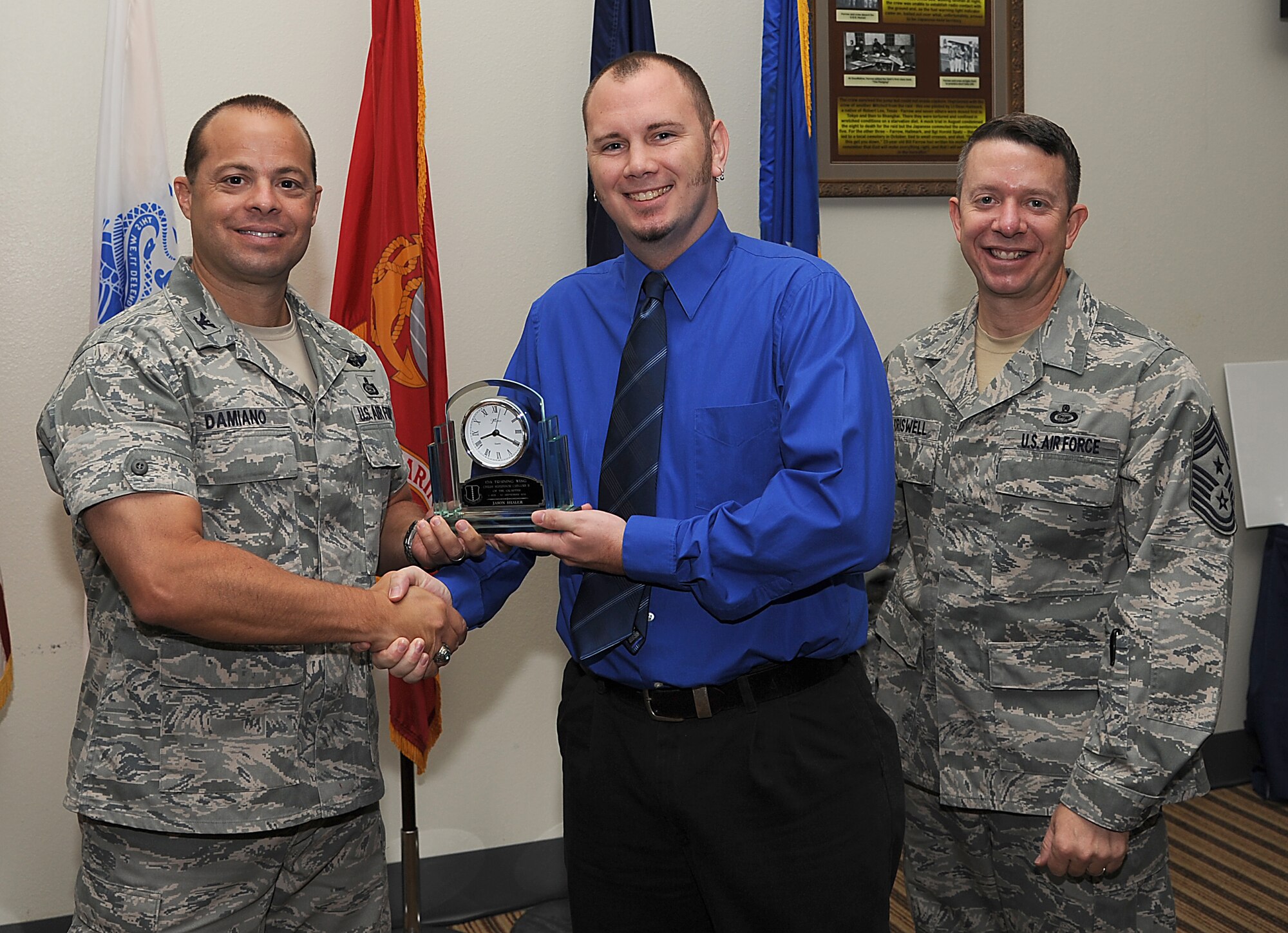 GOODFELLOW AIR FORCE BASE, Texas -- Col. Mark Damiano, 17th Training Wing Commander, and Chief Master Sgt. Brendan Criswell, 17th TRW Command Chief, present Jason Shaler, 17th Training Group, with the 17th TRW Civilian Supervisor Category II of the Quarter Award for the third quarter. (U.S. Air Force photo/Airman 1st Class Michael Smith)