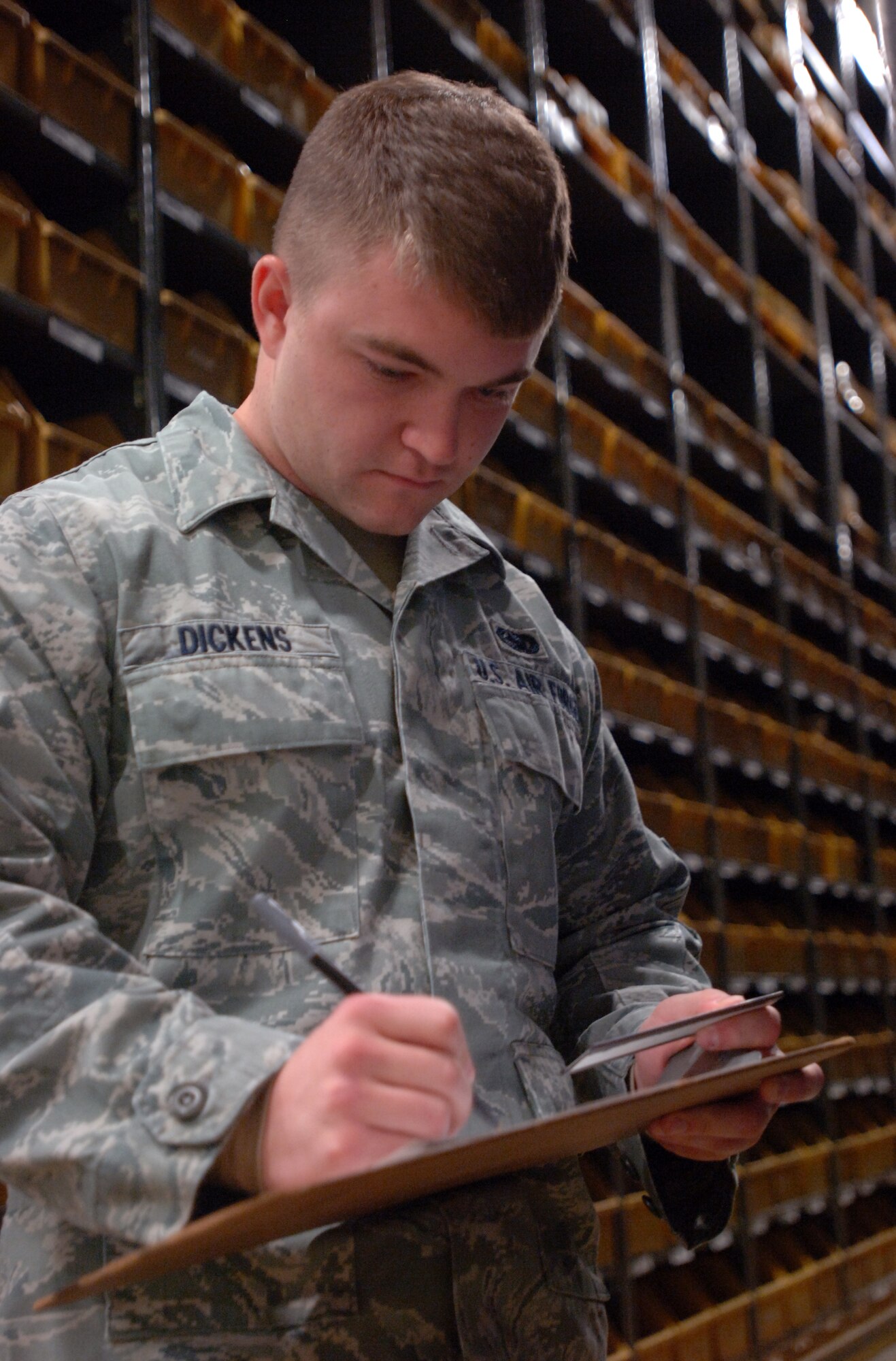 Airman 1st Class Joshua Dickens, with the 319th Logistical Readiness Squadron, checks inventory at work on Oct. 20. (U.S. Air Force photo by Tim Flack)