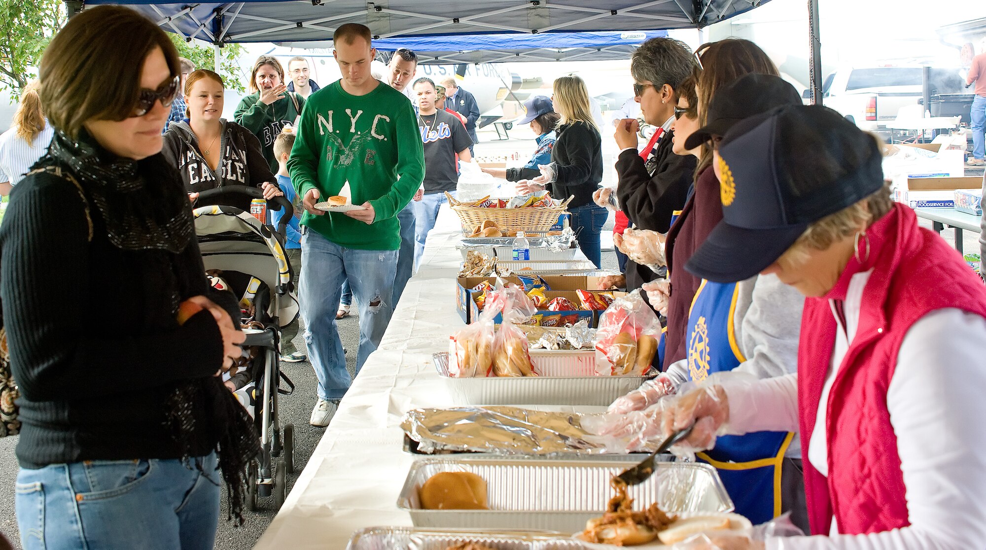 Service members and their families take part in a free food buffet provided
by Dover Capital City Rotary at the AMC Museum Oct. 22, 2011 in Dover, Del. Food,
musical entertainment and children's bouncy castles were all part of the
second annual rotary sponsored Military Appreciation Day. (Air
Force photo by Master Sgt. Sheri Kangas) 
