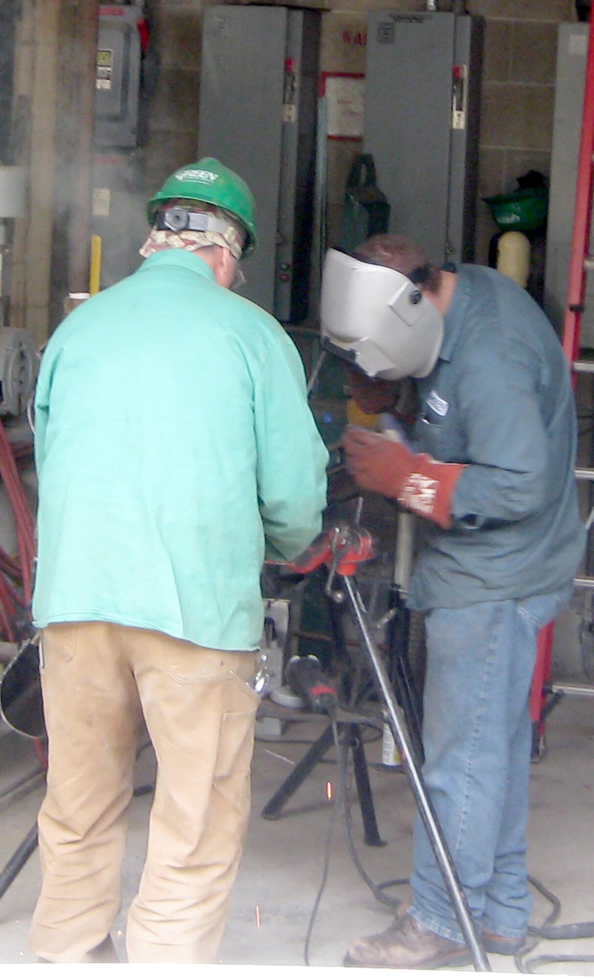 Contractors fabricate new boiler piping April 5, 2011, outside of Building 714 at Dover Air Force Base, Del. The boilers are part of an American Recovery and Reinvestment Act of 2009 funded project to decentralize the 1950's era heat plant.  (U.S. Air Force courtesy photo) 