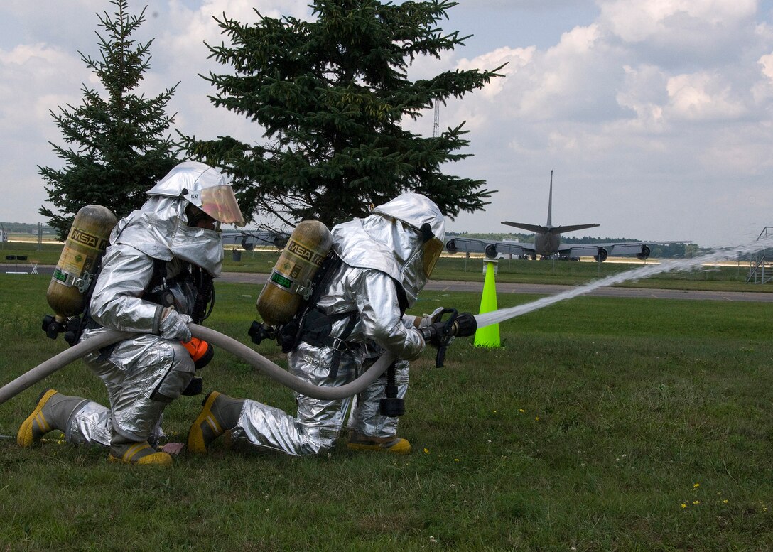 Tech. Sgt. Jeremy Murphy, 137 Air Refueling Wing, and Senior Airman Tyler Sorrels, 507th Air Refueling Wing, water sweep a simulated fire during an Operational Readiness Training Preparation on Aug. 6 at Volk Field Combat Readiness Training Center, Wisc
(U.S. Air Force Photo by Master Sgt Roberta Thompson/Released)