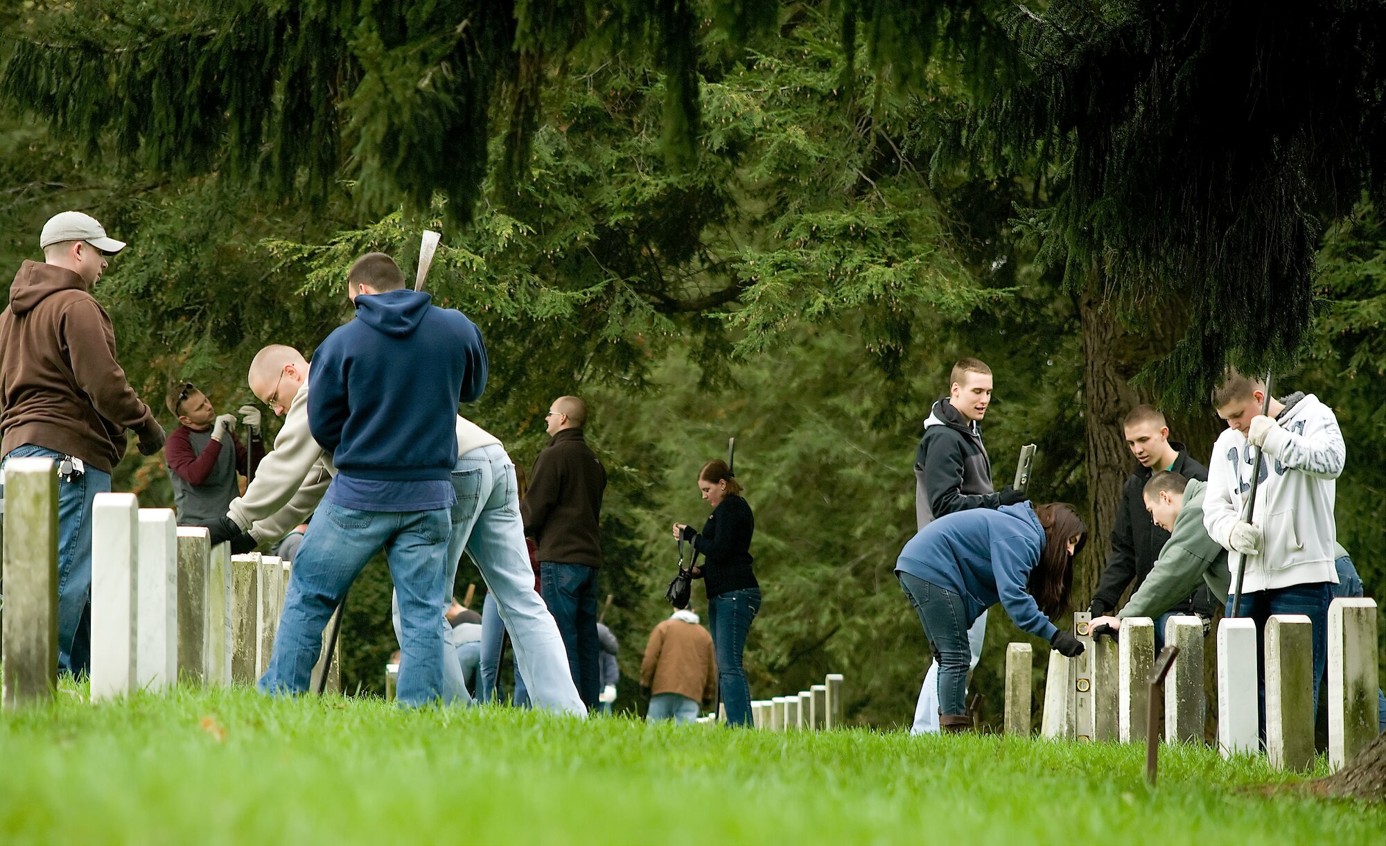 Team Dover members straighten grave stones at the Gettysburg National Military Park cemetery Oct. 21, 2011. More than 100 members from Dover Air Force Base, Del., traveled three hours to the park to participate in the Air Force Sergeants Association sponsored event.  (U.S. Air Force photo by Airman 1st Class Jacob Morgan)