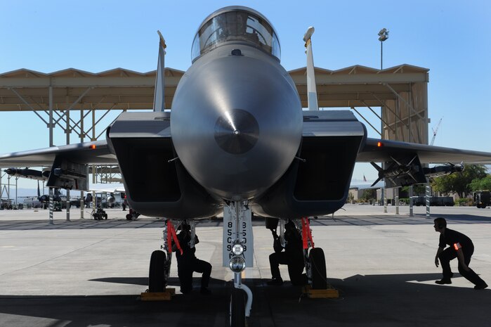 U.S. Air Force crew chiefs from the 757th Aircraft Maintenance Squadron recover Capt. David Vincent, 65th Aggressor Squadron pilot, after the first flight of an F-15 Eagle with an updated "Splinter" paint scheme Oct. 20, 2011, at Nellis Air Force Base, Nev.  The updated Russian paint scheme promotes realistic threat replication when participating in simulated air to air combat.  (U.S. Air Force photo by Staff Sgt. William P.Coleman/Released)