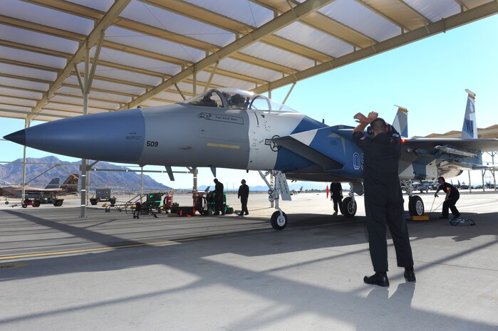 U.S. Air Force Airman 1st Class Michael Summet, 757th Aircraft Maintenance Squadron crew chief, recovers Capt. David Vincent, 65th Aggressor Squadron pilot, after the first flight of an F-15 Eagle with an updated "Splinter" paint scheme Oct. 20, 2011, at Nellis Air Force Base, Nev.  The updated Russian paint scheme promotes realistic threat replication when participating in simulated air to air combat.  (U.S. Air Force photo by Staff Sgt. William P.Coleman/Released)