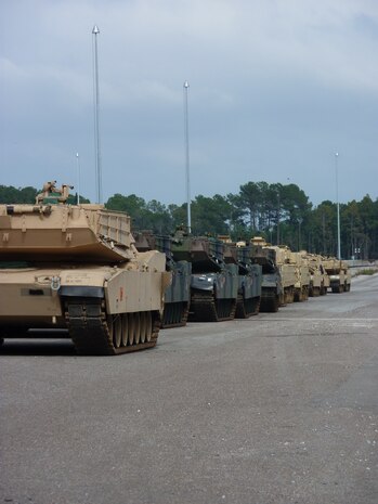 Track vehicles stage in preparation for loading onto railcars at Joint Base Charleston - Weapons Station, Oct. 21. The 841st Transportation Battalion, which is responsible for moving re-deploying cargo that is off-loaded at JB Charleston, loaded 44 track vehicles onto 22 railcars for shipment to multiple locations across the United States.The 841st is a subordinate unit of the Military Surface Deployment and Distribution Command and conducts surface deployment distribution and water terminal operations along the Atlantic Seaboard. (U.S. Army photo/Maj. Scott Hammond)