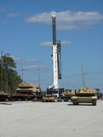 A 70-ton crane gets into position to lift a disabled tank onto a railcar at Joint Base Charleston - Weapons Station Oct. 21. The 841st Transportation Battalion, which is responsible for moving re-deploying cargo that is off-loaded at JB Charleston, loaded 44 track vehicles onto 22 railcars for shipment to multiple locations across the United States.The 841st is a subordinate unit of the Military Surface Deployment and Distribution Command and conducts surface deployment distribution and water terminal operations along the Atlantic Seaboard. (U.S. Army photo/Maj. Scott Hammond)