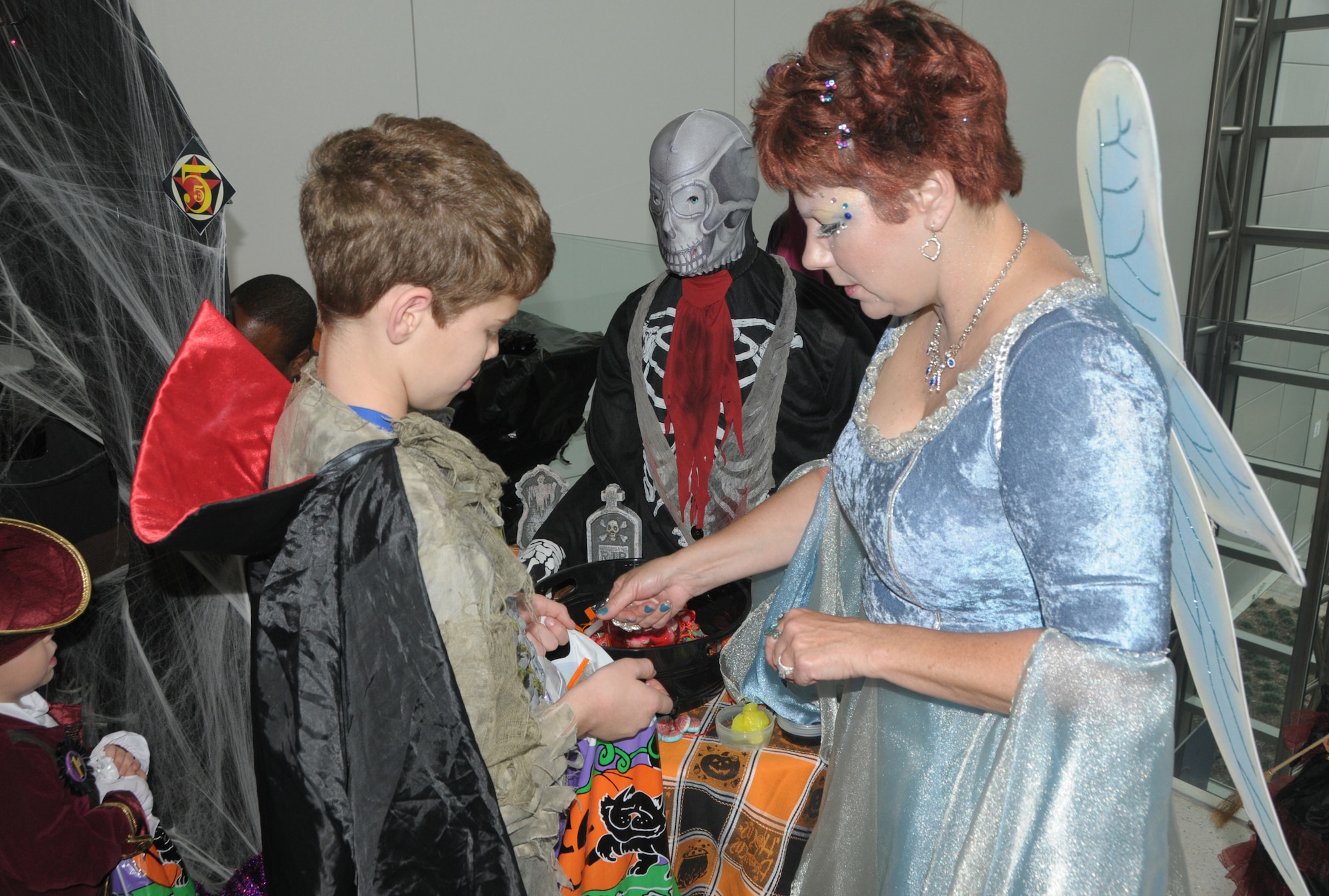 Staff Sgt. Tammy O'Neil of Family Programs, hands out candy to children who participated in Halloween festivities on October 22, 2011 at the Air National Guard Readiness Center, Joint base Andrews, MD.  (U.S. Air Force photo by Staff Sergeant Lorenzo Parnell) (Released)


