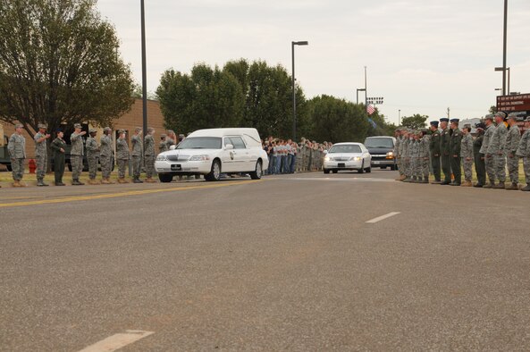 Members of the Will Rogers Air National Guard here render salutes during the processional of 2nd Lt. Jered Ewy, of the 45th Infantry Brigade on Aug. 7, 2011. Ewy died during his third tour in Afghanistan. 