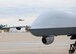 A MQ-9 Reaper from the 174th Fighter Wing, New York Air National Guard, taxis in front of a Blackhawk helicopter in preparation for the MQ-9's first training flight from Wheeler-Sack Army Airfield at Ft. Drum, NY on 18 October 2011. The 174th Fighter Wing has begun flying the remotely piloted aircraft in restricted airspace around Ft. Drum to train pilots and sensor operators working from Syracuse’s Hancock Field. (Photo by Staff Sgt. Ricky Best)