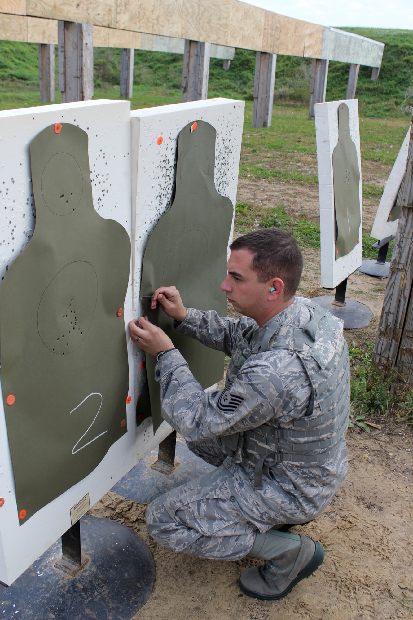 TSgt. Derek Elsey places a fresh sheet on a target at the Combat Arms Training and Maintenance (CATM) range at Selfridge Air National Guard Base, Oct. 23, 2011. The Air Force is expanding its small arms training program for all Airmen who are preparing to be forward deployed. The new requirements go into effect on Dec. 1, 2011. Elsey is a CATM instructor for the 127th Security Forces Squadron. (U.S. Air Force photo  by TSgt. Dan Heaton)