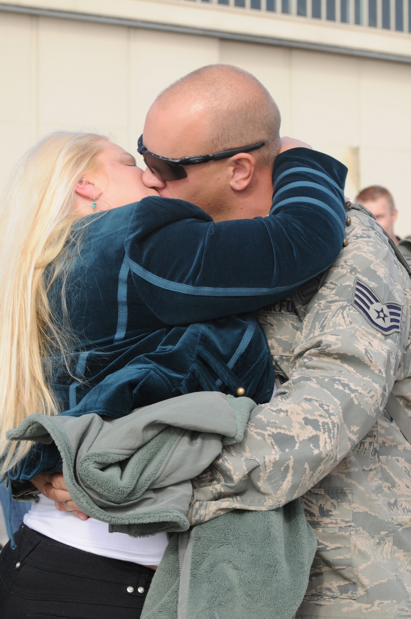 Staff Sgt. Nathan Werley, 555th Fighter Squadron weapons load crew chief, greets his wife Norma Jean with a kiss Oct. 24 at Aviano Air Base, Italy, after returning from a six-month deployment to Afghanistan as part of the 555th Aviation Package. Airmen and civilians from multiple squadrons in the 31st Fighter Wing supported the 555th FS Triple Nickel’s six-month deployment to Afghanistan. (U.S. Air Force photo/Airman 1st Class Jenay Randolph)