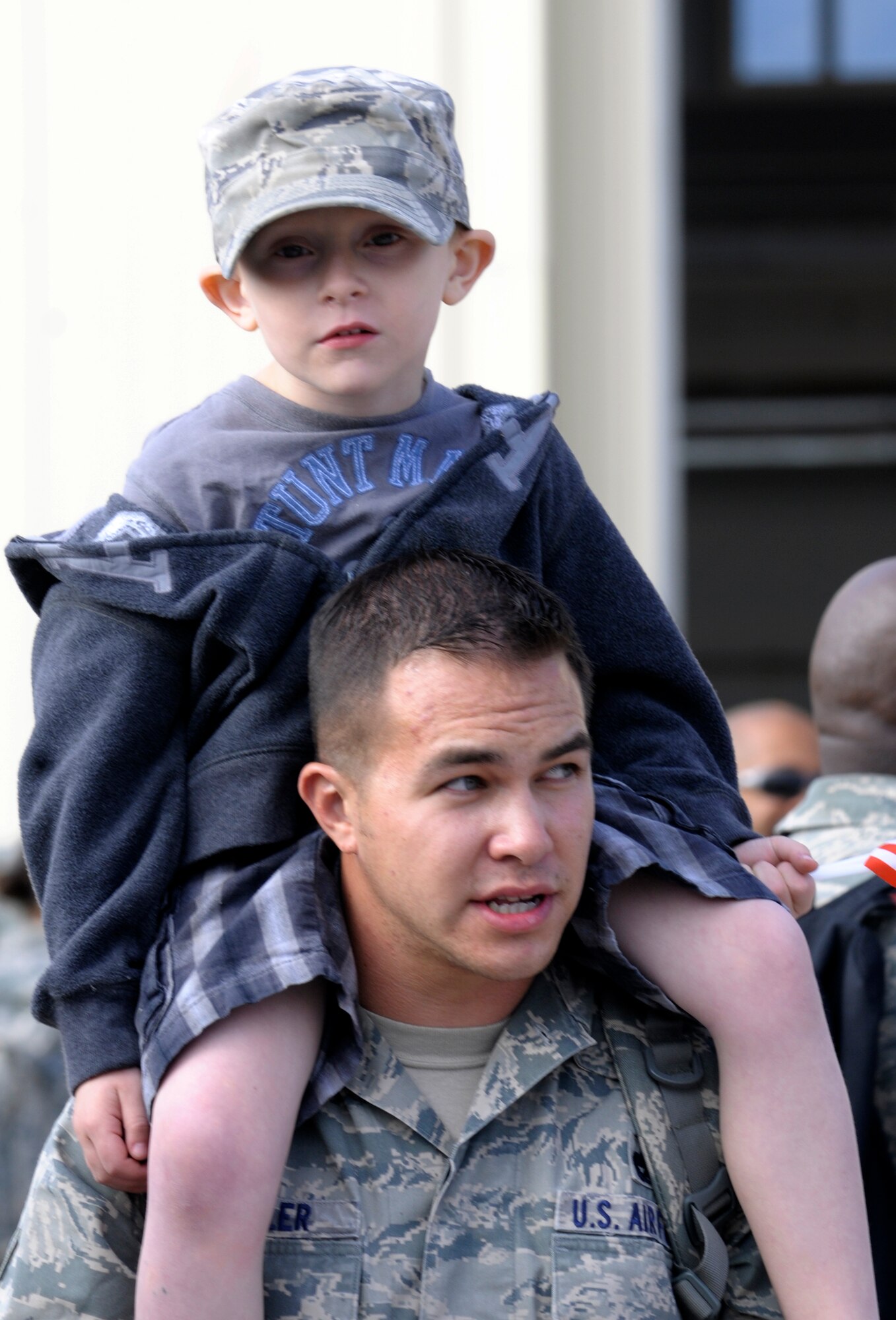 Staff Sgt. Matthew Swindler, 555th Fighter Squadron NCO in charge of shipping and recieving, greets his son, Tyler, Oct. 24 at Aviano Air Base, Italy. Swindler and other Airmen and civilians with the 555th Aviation Package received a warm welcome from families, friends and coworkers after returning from their six-month deployment to Afghanistan. (U.S Air Force photo/Airman 1st Class Briana Jones)