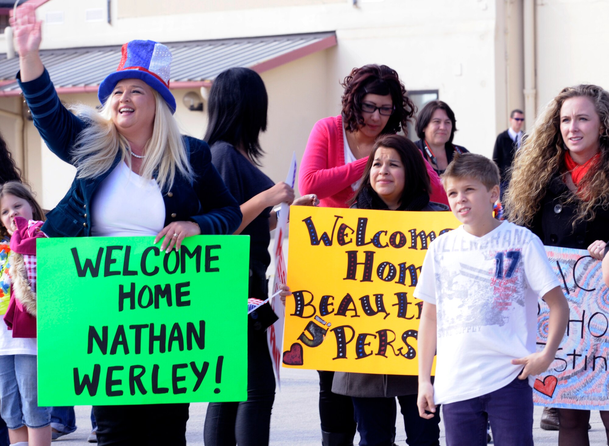 Families, friends, and coworkers wait for members of the 555th Aviation Package to return from deployment Oct. 24 at Aviano Air Base, Italy. Airmen and civilians from multiple squadrons in the 31st Fighter Wing supported the 555th Fighter Squadron Triple Nickel’s six-month deployment to Afghanistan. (U.S. Air Force photo/Airman 1st Class Briana Jones)