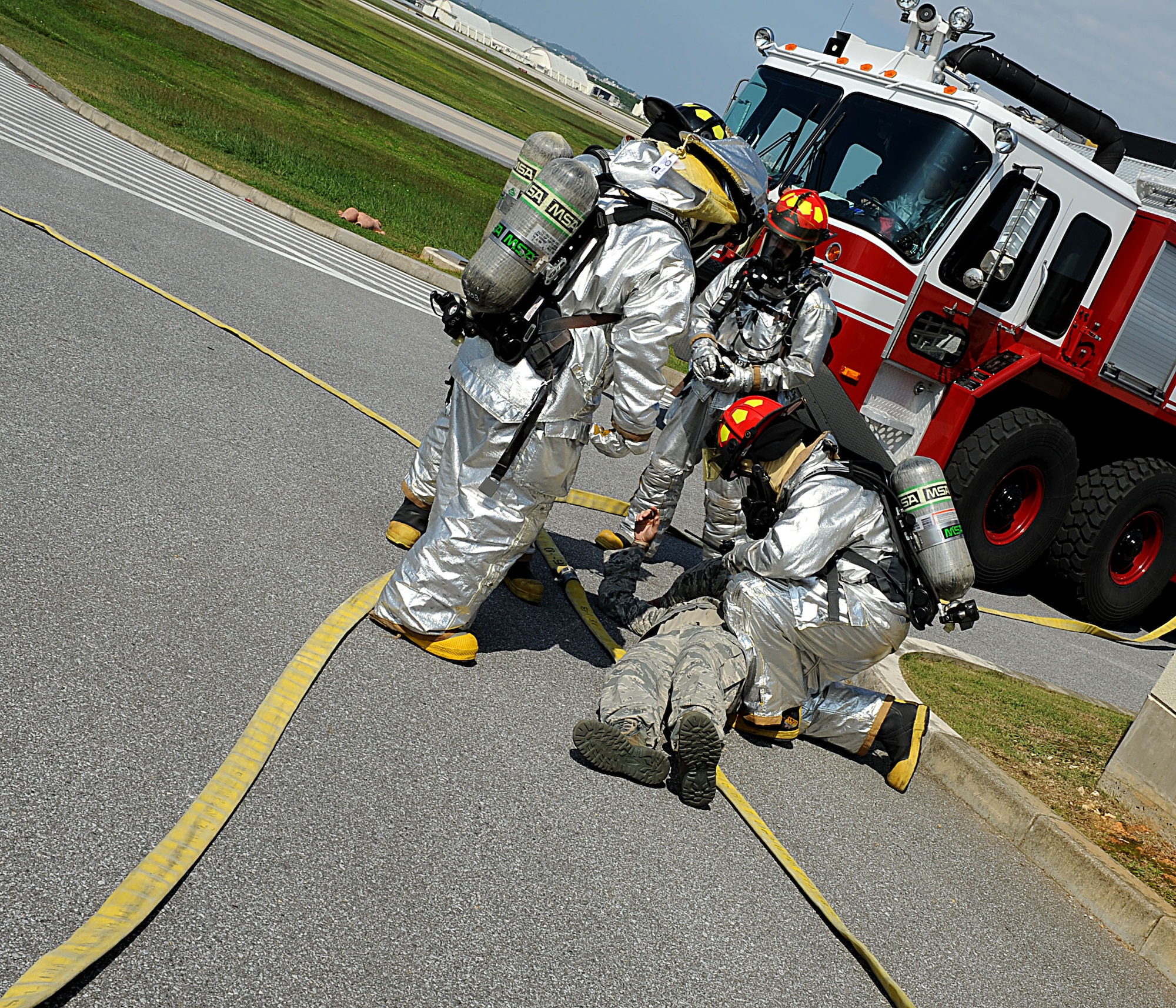 18th Civil Engineer Squadron U.S. Air Force firefighters provide care to a simulated victim of a plane crash during a training inject for local operational readiness exercise Beverly High 12-1 on Kadena Air Base, Japan, Oct. 25. 18th CES firefighters responded to the scenario but left early due to a real-world fire response. (U.S Air Force photo/Airman 1st Class Brooke P. Beers/Released)