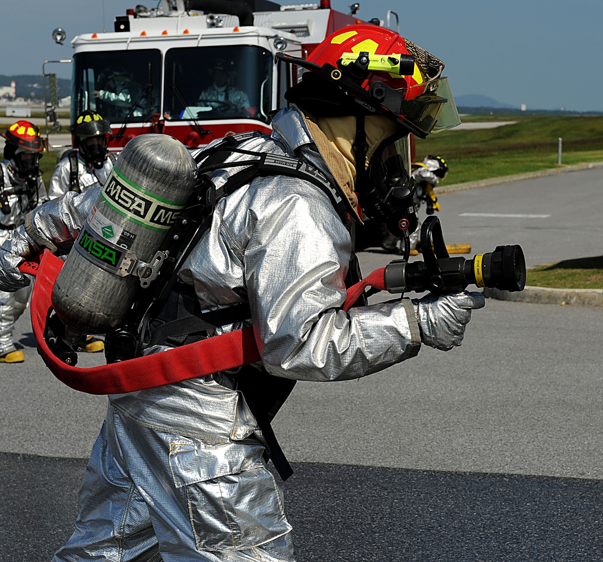 An 18th Civil Engineer Squadron U.S. Air Force firefighter approaches a simulated plane crash during a training scenario for the local operational readiness exercise Beverly High 12-1 on Kadena Air Base, Japan, Oct. 25. LOREs allow for Kadena Airmen to train in a safe environment for later real-world contingencies. (U.S Air Force photo/Airman 1st Class Brooke P. Beers/Released)