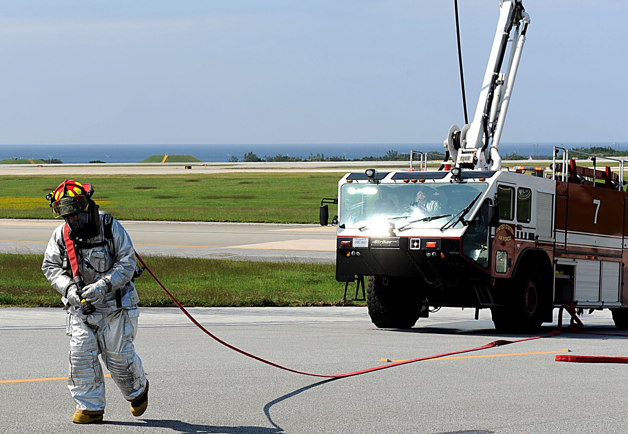 An 18th Civil Engineer Squadron U.S. Air Force firefighter approaches a simulated plane crash during a training scenario for the local operational readiness exercise Beverly High 12-1 on Kadena Air Base, Japan, Oct. 25. LOREs prepare Kadena Airmen for real-world contingencies by providing a safe training environment in which to simulate emergencies.  (U.S Air Force photo/Airman 1st Class Brooke P. Beers/Released)