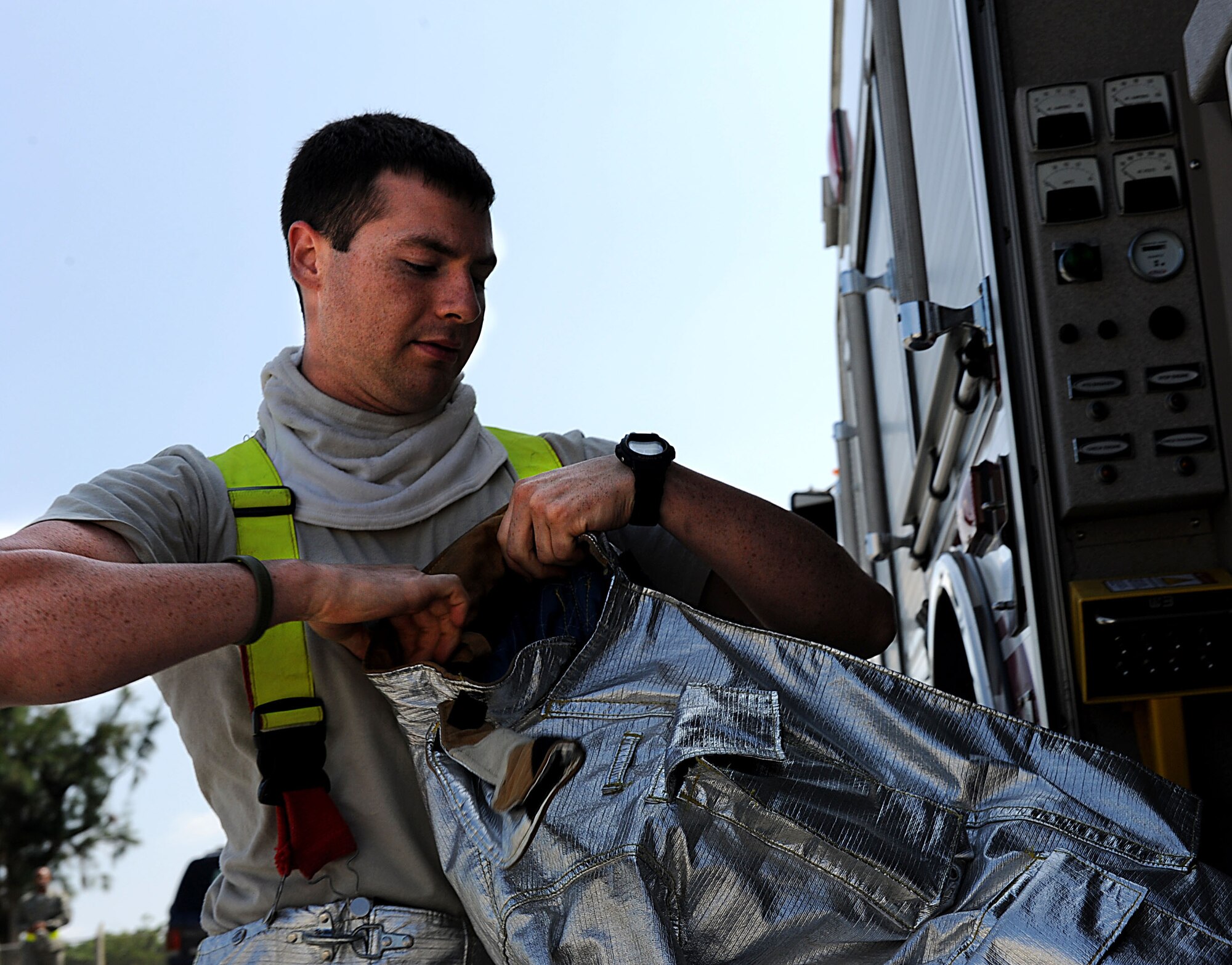 U.S. Air Force Airman 1st Class Skyler Dreyer, 18th Civil Engineer Squadron firefighter, gears up during a training scenario for local operational readiness exercise Beverly High 12-1 on Kadena Air Base, Japan, Oct. 25. LOREs prepare Kadena Airmen for real-world contingencies by providing a safe training environment in which to simulate emergencies. (U.S Air Force photo/Airman 1st Class Brooke P. Beers/Released)