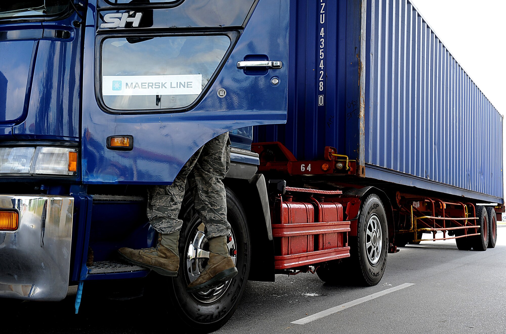 U.S. Air Force Airman 1st Class Benjamin Sanders, 18th Security Forces Squadron installation entry controller, checks a vehicle for explosives and other paraphernalia Oct. 25 on Kadena Air Base, Japan. Although Team Kadena is currently participating in local operational readiness exercise Beverly High 12-1, real-world mission requirements must still be met. (U.S. Air Force photo/Staff Sgt. Christopher Hummel/released)