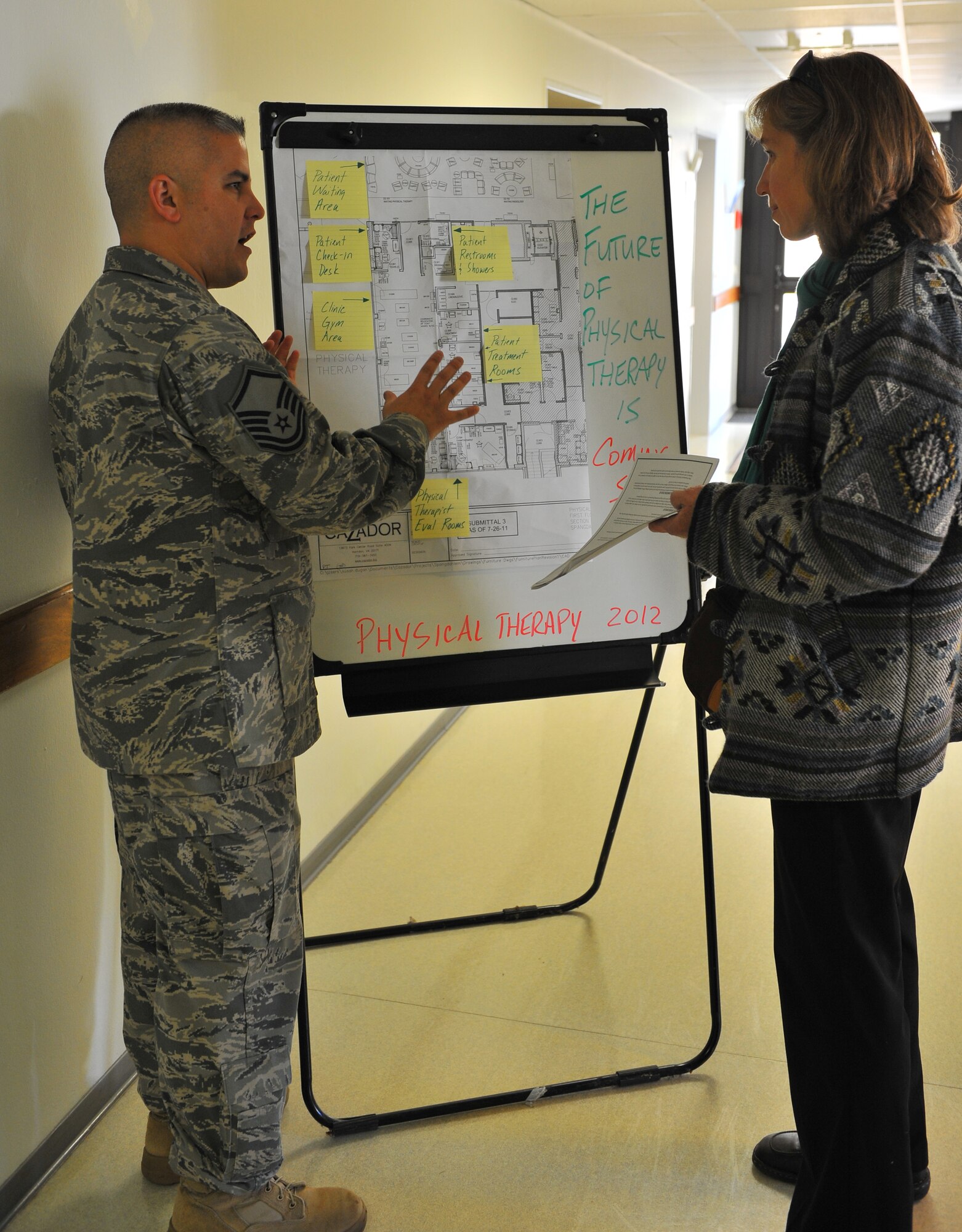 SPANGDAHLEM AIR BASE, Germany – Master Sgt. Toby Urenda, 52nd Medical Operations Squadron physical therapist, explains the layout of the new physical therapy section that will be located in the new medical clinic to Cathron Donaldson, 52nd Medical Operations Squadron Educational and Developmental Intervention Services physical therapist, during the physical therapy open house here Oct. 21. The open house allowed guests to learn about preventative safety measures for working out and enabled the clinic to showcase the services they provide to Airmen and families. (U.S. Air Force photo/Airman 1st Class Dillon Davis)