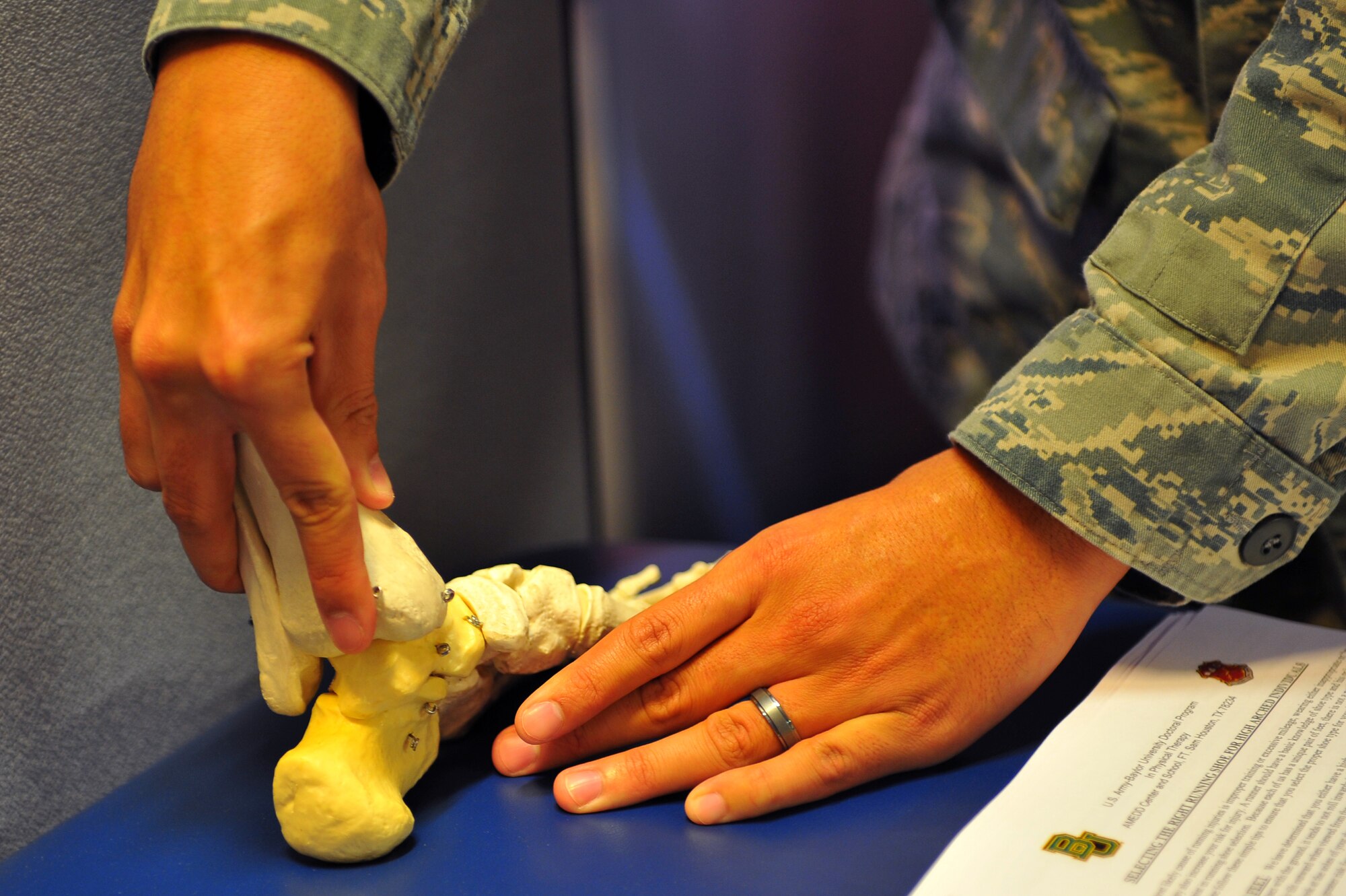 SPANGDAHLEM AIR BASE, Germany – Staff Sgt. Joseph Suarez, 52nd Medical Operations Squadron physical therapist, demonstrates the differences between the three main types of foot arches using a foot model during the physical therapy open house here Oct. 21. The open house allowed guests to learn about preventative safety measures for working out and enabled the clinic to showcase the services they provide to Airmen and families. (U.S. Air Force photo/Airman 1st Class Dillon Davis)
