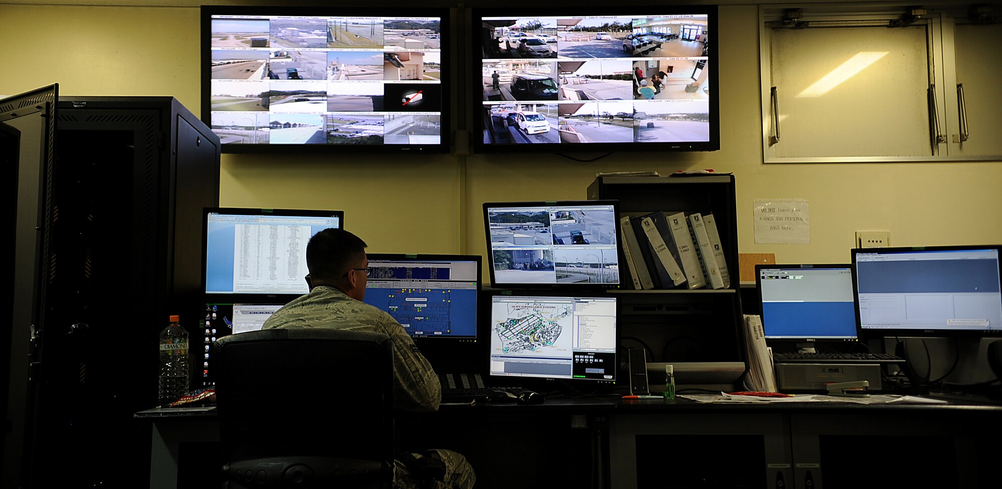 U.S. Air Force Airman 1st Class Ryan Bailey, 18th Security Forces Squadron alarm monitor, watches video feeds from around Kadena Air Base, Japan, as part of his daily duties Oct. 25. Although Team Kadena is currently participating in local operational readiness exercise Beverly High 12-1, real-world mission requirements must still be met. (U.S. Air Force photo/Staff Sgt. Christopher Hummel/released)