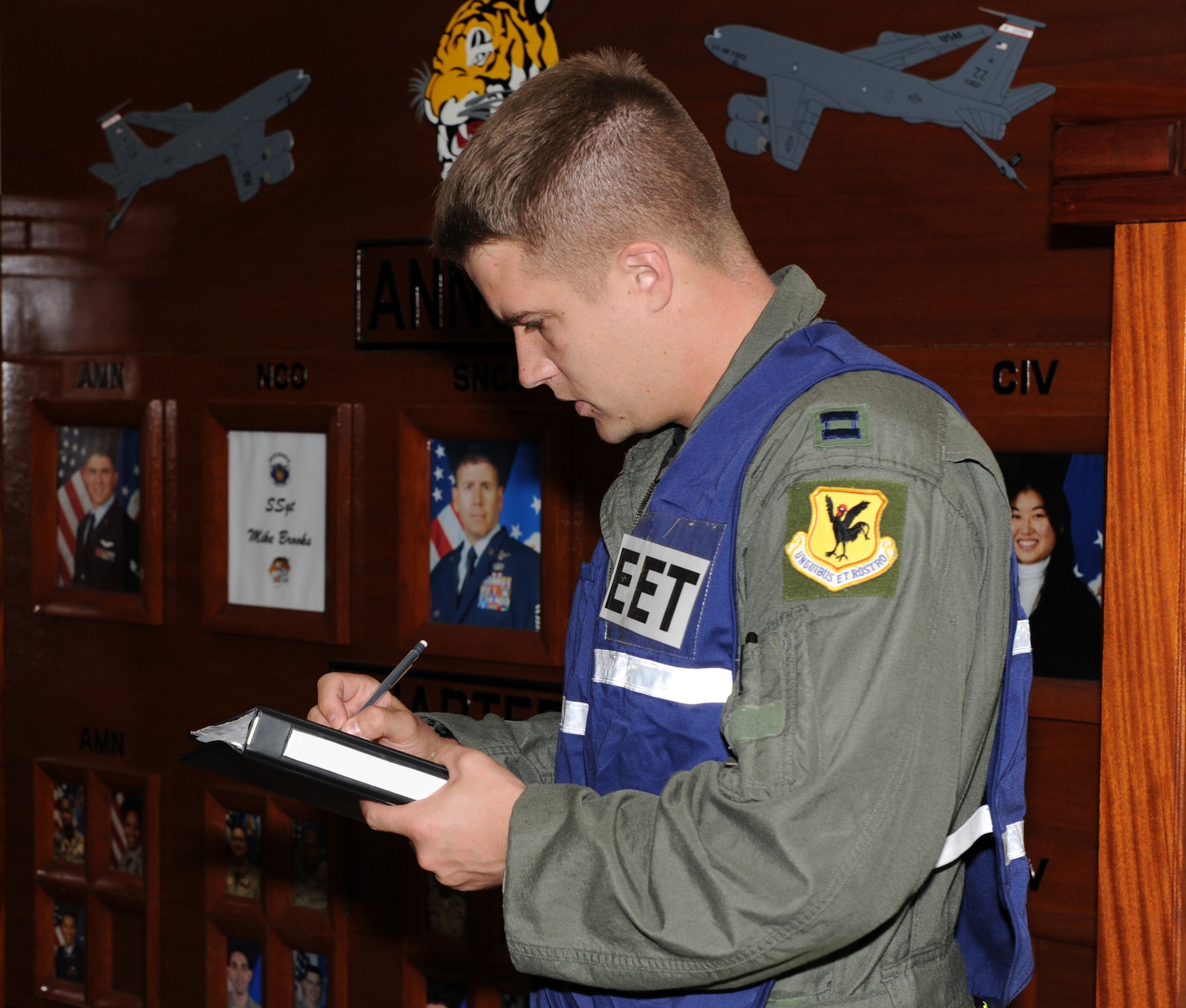 U.S. Air Force Capt. Stephen Grantier, 18th Operations Group exercise evaluation team member, evaluates how Airmen apply self-aid and buddy care during a suicide bomber scenario at the 909th Air Refueling Squadron during Beverly High 12-1, a local operational readiness exercise on Kadena Air Base, Japan, Oct. 25.  The 18th Wing is participating in the LORE Oct. 24-28 to test the readiness of Kadena Airmen. (U.S. Air Force photo/Junko Kinjo/Released) 