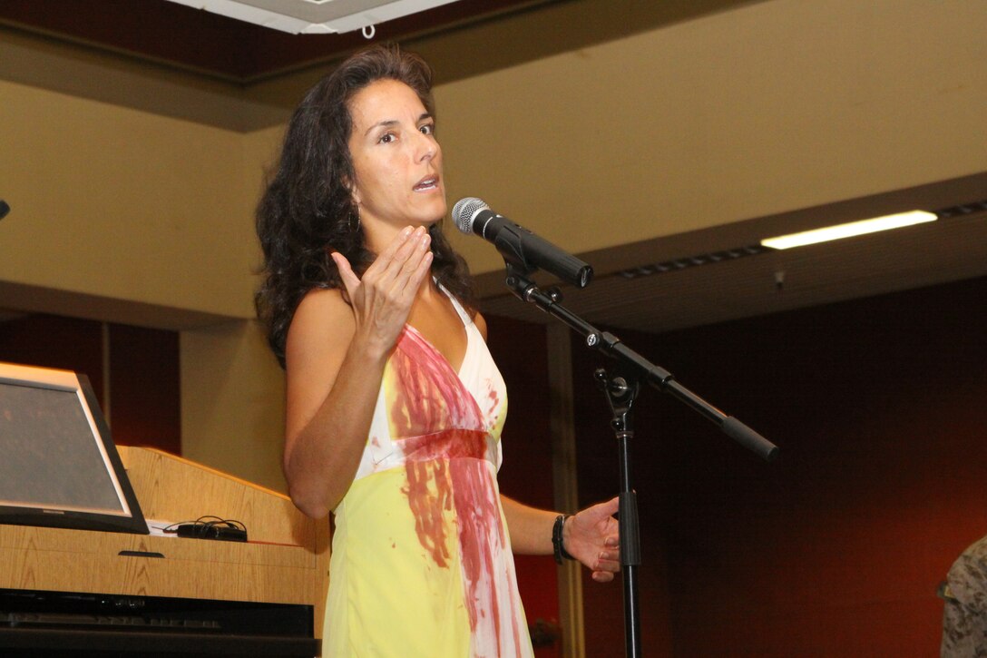 Actress Denise Dean tells the story of a girl named Anna and her abusive relationship that led to her death in a play entitled, "The Yellow Dress" aboard Marine Corps Recruit Depot San Diego Oct. 25. Anna told a detailed story, from the blissful beginning with her boyfriend, Rick, to bouts of jealousy and abuse that led to her death at his hands. In observance of Domestic Violence Awareness Month, Marines watched the 30-minute monologue to learn the warning signs and dynamic of abusive relationships.