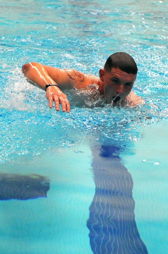 Lance Cpl. Cameron Phife, a member of the Official Marine Corps Color Guard, swims for the finish line during the Raging Rhino competition at the United States Naval Academy, Annapolis, Md., Oct. 25. The Raging Rhino was the 13th event in the Barracks' 17-event 2011 Commander's Cup series. Marines were timed in running two miles, swimming 300 meters, running one more mile and finishing the race with a 150 meter swim. (Official Marine Corps Photo by Lance Cpl. Mondo Lescaud)