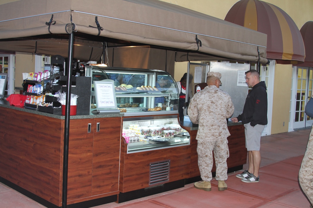 Marines purchase breakfast items at Duncan Hall's new breakfast kiosk Oct. 25. The new kiosk offers breakfast sandwiches, self-serve beverages, pastries, fresh fruit bowls, coffee, iced coffee, cappuccinos and lattes. "It allows more flexibility with what we can prepare for the Marines," said Mike Wolfenden, general manager, Duncan Hall, Marine Corps Recruit Depot San Diego. "It also allows for Marines to pick up some chow if they don't have the time to change out of their physical training gear."