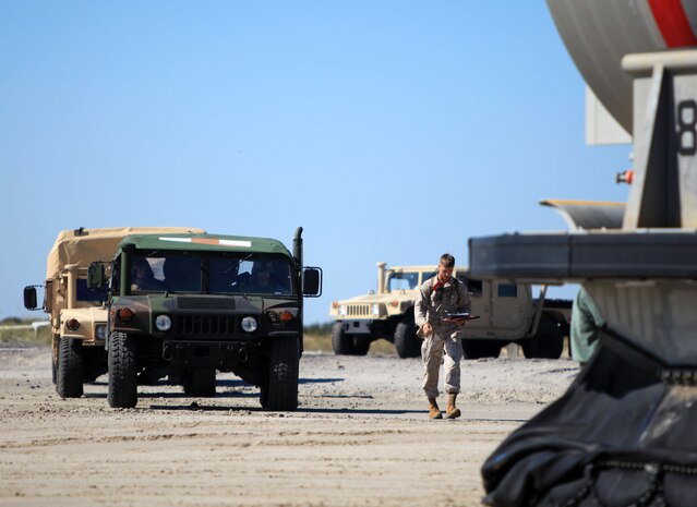 MARINE CORPS BASE CAMP LEJEUNE N.C. –High Mobility Multipurpose Wheeled Vehicles (HMMWV) prepare to load onto a Landing Craft Air Cushioned hovercraft (LCAC) on Onslow Beach aboard Camp Lejeune, N.C., Oct. 25, 2011, as part of the Amphibious Squadron 8 (PHIBRON 8) / 24th Marine Expeditionary Unit (MEU) Integration Training exercise (PMINT). PMINT is taking place Oct. 24 to Nov. 3 and is focused on building the Navy-Marine Team and establishing the working relationships and practices necessary to conduct operations from the sea. (Official USMC Photo by: Lance Cpl Michael J. Petersheim/ Released)