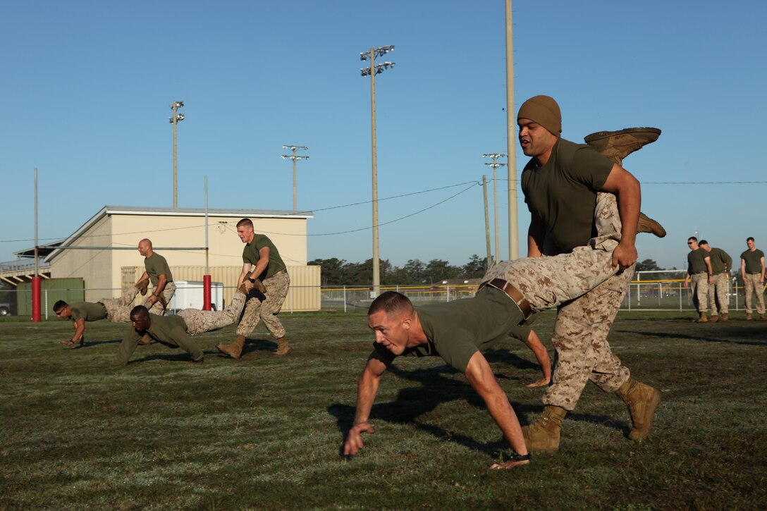 Marine compete in the wheel barrel race during the Headquarters and Support Battalion Commanders Cup Challenge field meet aboard Marine Corps Base Camp Lejeune, Oct. 26