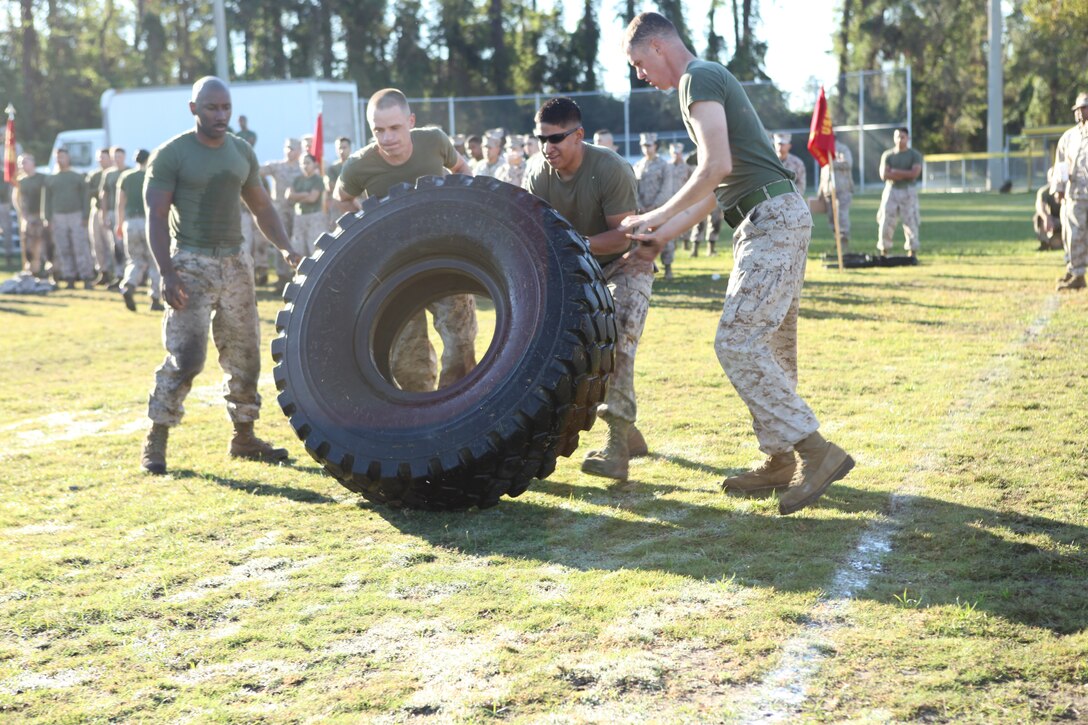 Marines compete in the tire flipping contest during the Headquarters and Support Battalion Commanders Cup Challenge field meet aboard Marine Corps Base Camp Lejeune, Oct. 26