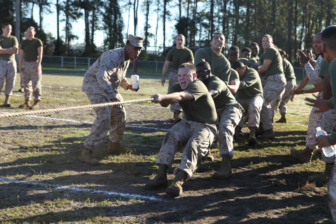 Marines with Company A, Headquarters and Support Battalion, Marine Corps Base Camp Lejeune, motivate each other to dig their feet and keep pulling during the tug-o-war even at the Headquarters and Support Battalion Field Meet at Liversedge Field aboard the base, Oct. 26. The Company A Marines went undefeated in the tug-o-war portion of the meet, but still came in second place after Company B Marines pulled away from them in the finale.