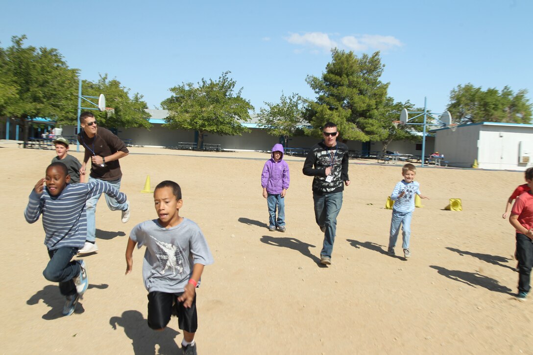 Marines gather around a gear display to see how to organize their items for a battalion commander’s inspection at the bulk fuel depot on Camp Hansen Oct. 26. The Marines with 9th Engineer Support Battalion, 3rd Marine Logistics Group, III Marine Expeditionary Force had the inspection to ensure all of their equipment was ready for the upcoming deployment to Afghanistan.
