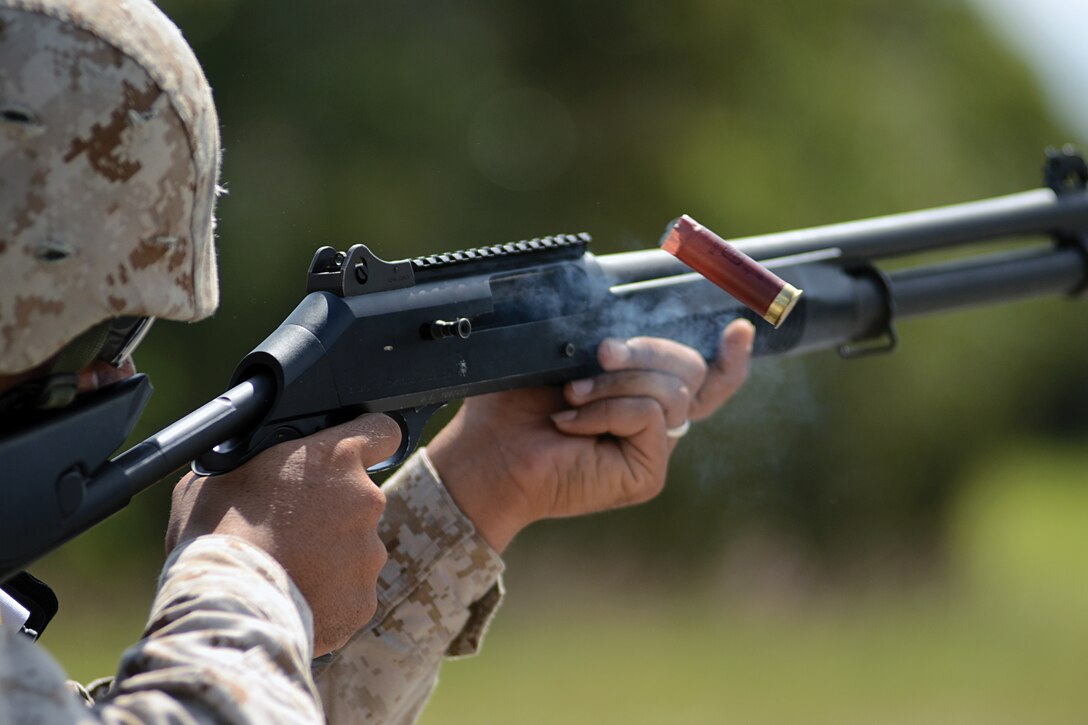 Sgt. George M. Frasier uses a combat stance to absorb the recoil of an M1014 joint service combat shotgun at Landing Zone Wren in the Central Training Area Oct. 26. Frasier is with Special Operations Training Group. He was training with Military Police Company, Headquarters Battalion, 3rd Marine Division, III Marine Expeditionary Force, for the day.