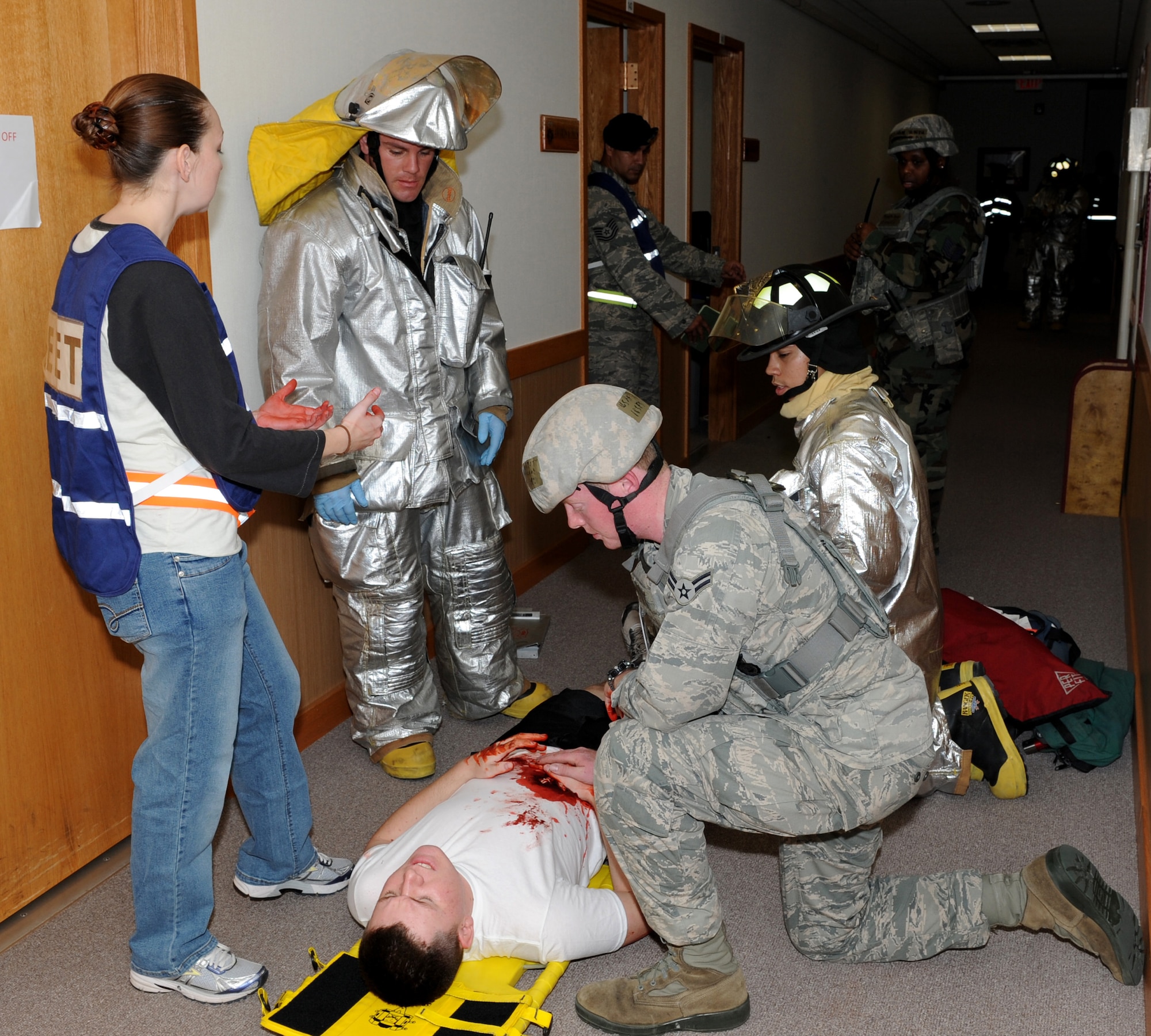 U.S. Air Force Staff Sgt. Cynthia Evans, 18th Dental Squadron moulage team member and exercise evaluation team member, guides players in the right way during an active shooter scenario at the 909th Air Refueling Squadron during Beverly High 12-1, a local operational readiness exercise on Kadena Air Base, Japan, Oct. 26. During the LORE, many EET members are on-scene to evaluate Airmen in ways such as safety and immediate reaction. (U.S. Air Force photo/Junko Kinjo/Released) 