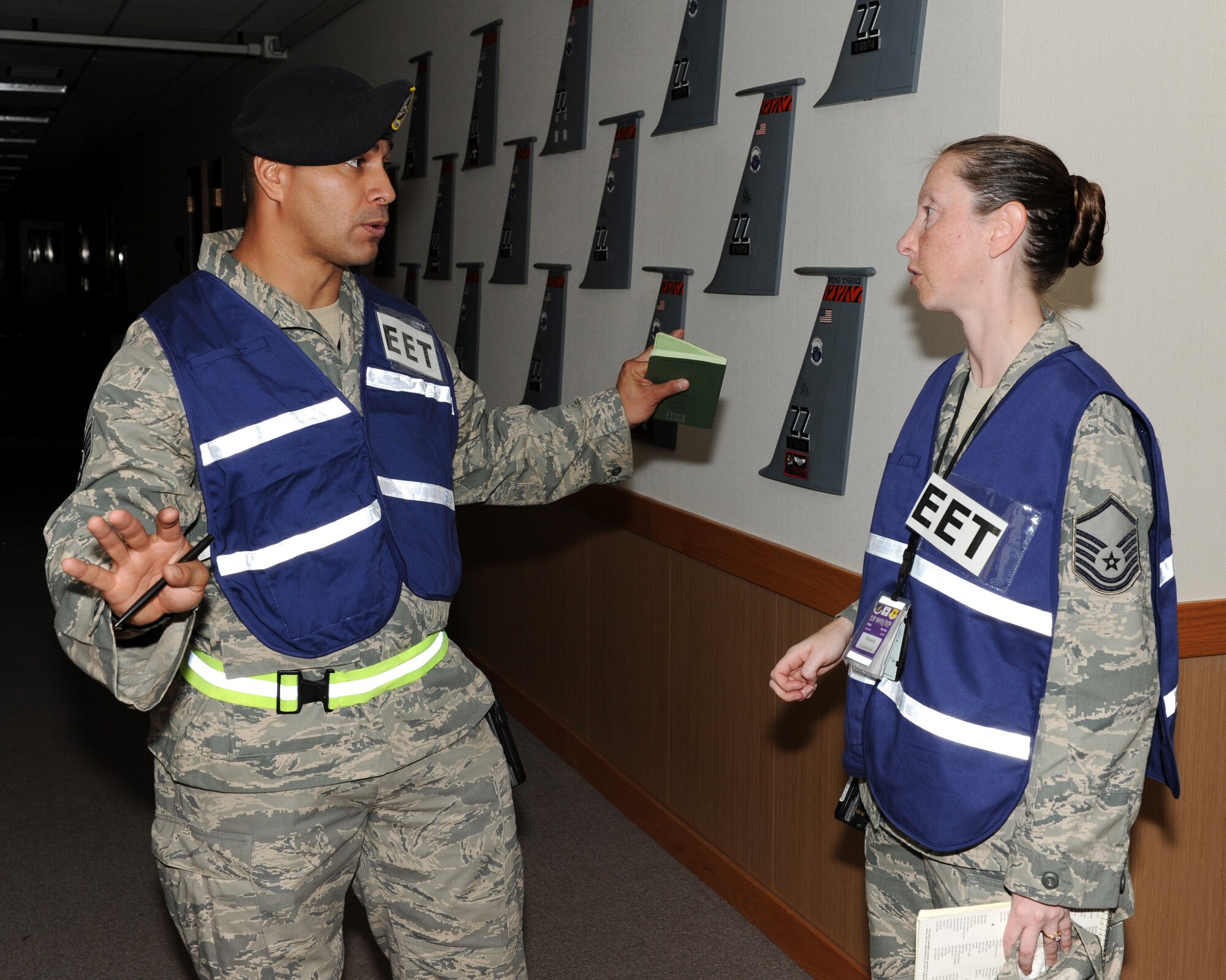 U.S. Air Force Tech Sgt. Jason Rangel, 18th Security Forces Squadron exercise evaluation team member, and U.S. Air Force Master Sgt. Andrea Barnes, 18th Wing Plans superintendent of exercises, both discuss an active shooter scenario at the 909th Air Refueling Squadron during Beverly High 12-1, a local operational readiness exercise on Kadena Air Base, Japan, Oct. 26. During the LORE, many EET members are on-scene to evaluate Airmen in ways such as safety and immediate reaction. (U.S. Air Force photo/Junko Kinjo/Released) 