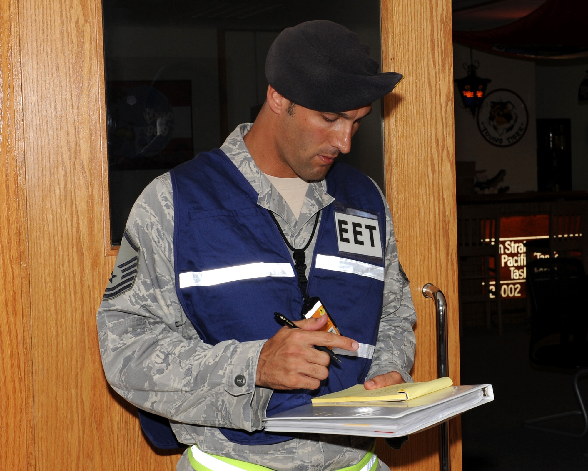 U.S. Air Force Master Sgt. Brandon Wolfgang, 18th Security Forces Squadron exercise evaluation team member, evaluates how Airmen capture an active shooter during an active shooter scenario at the 909th Air Refueling Squadron during Beverly High 12-1, a local operational readiness exercise on Kadena Air Base, Japan, Oct. 26.  The 18th Wing is participating in the LORE Oct. 24-28 to test the readiness of Kadena Airmen. (U.S. Air Force photo/Junko Kinjo/Released)