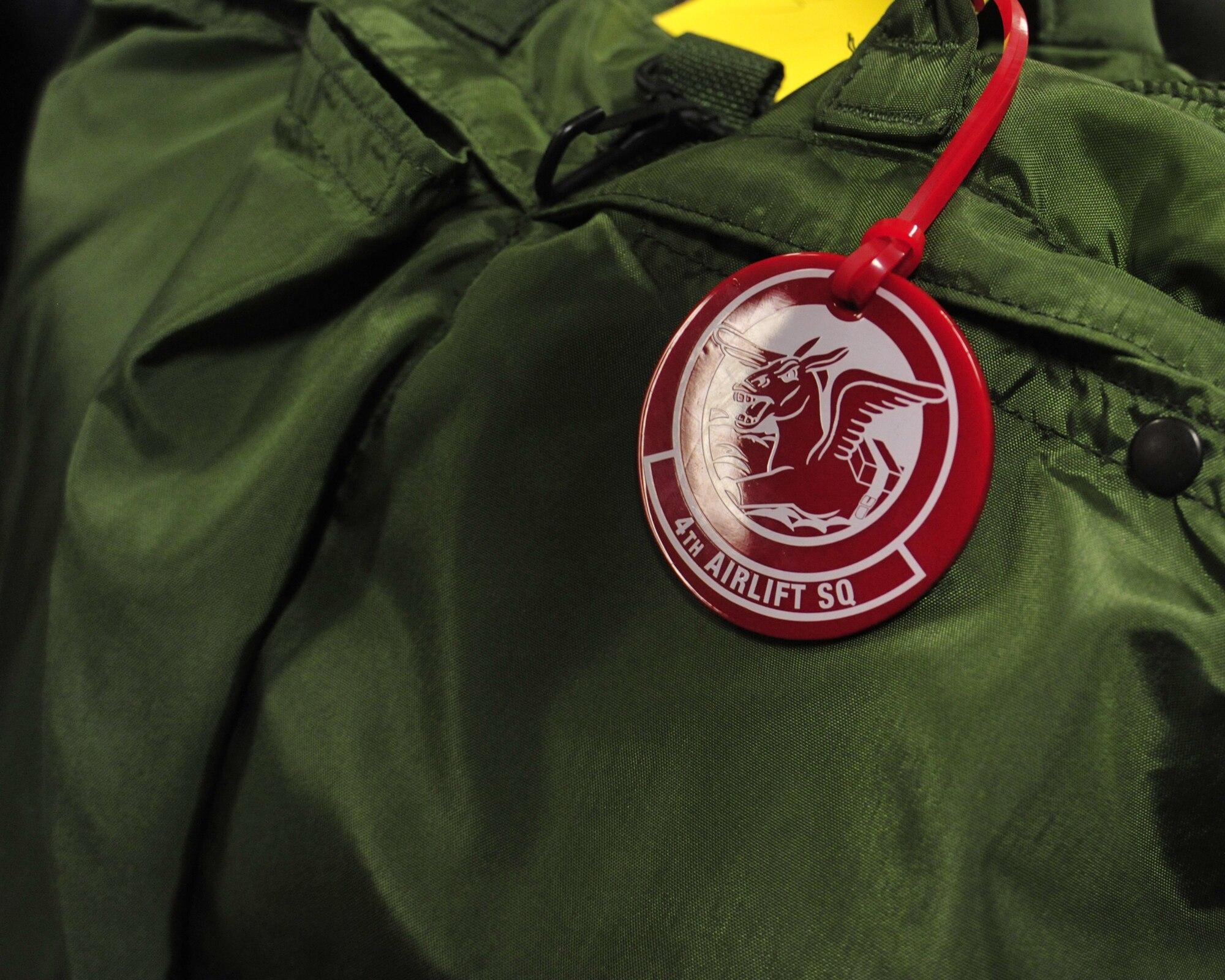 A carry-on bag belonging to a member of the 4th Airlift Squadron is placed on the ground while they wait to depart for a deployment Oct. 25, 2011, at Joint Base Lewis-McChord, Wash. The 4th AS deployed to the Middle East in support of Operations Enduring Freedom and New Dawn. (U.S. Air Force photo/Staff Sgt. Frances Kriss)