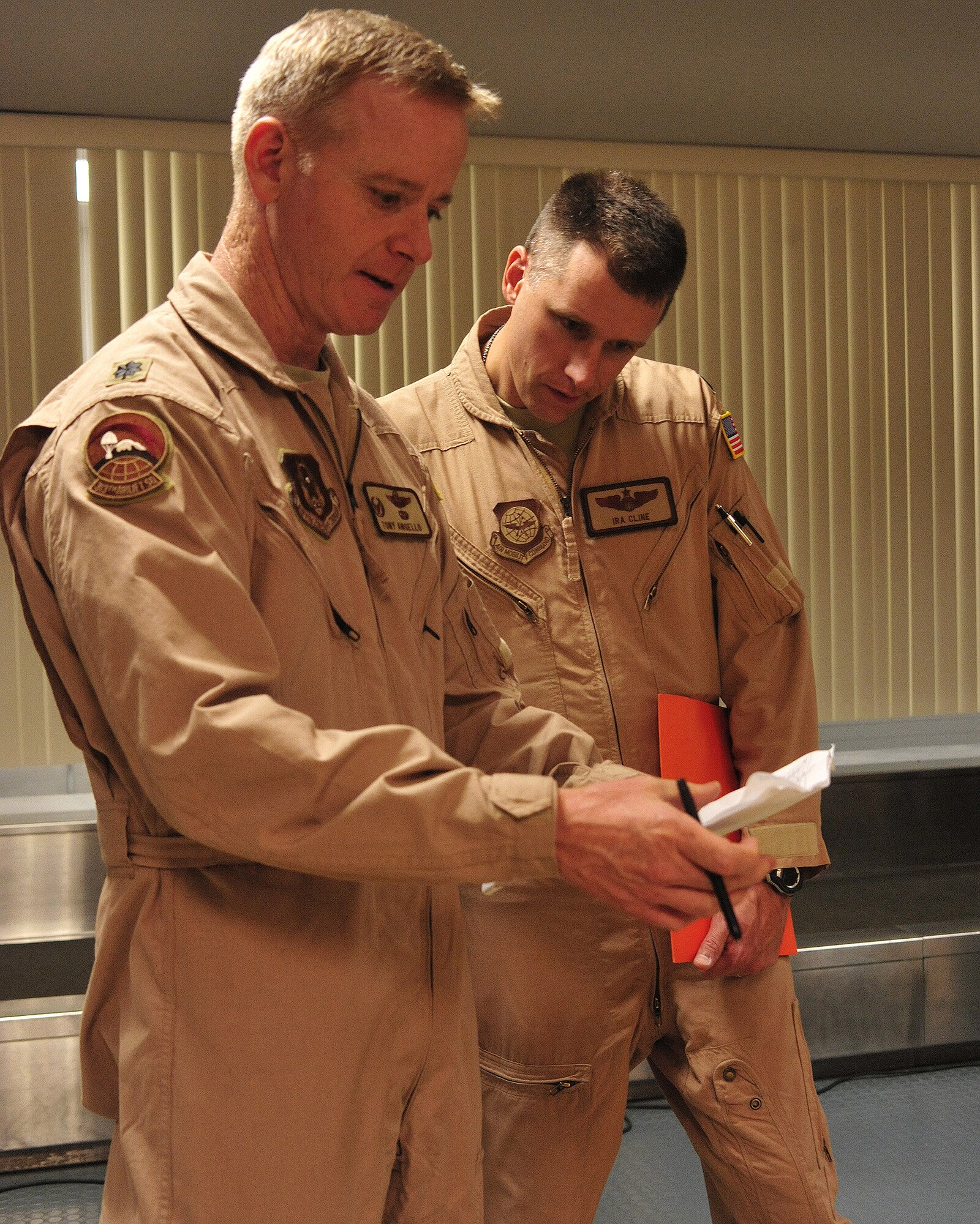 Lt. Col. Anthony Angello, 313th Airlift Squadron commander under the 446th Airlift Wing, and Lt. Col. Ira Cline, 4th Airlift Squadron director of operations, conduct roll call prior to a deployment Oct. 25, 2011, at Joint Base Lewis-McChord, Wash. The 4th AS deployed to the Middle East and will take over operations of the 817th Expeditionary Airlift Squadron. Angello, who will be the 817th EAS commander, is the first Reservist to lead the active duty squadron. (U.S. Air Force photo/Staff Sgt. Frances Kriss)
